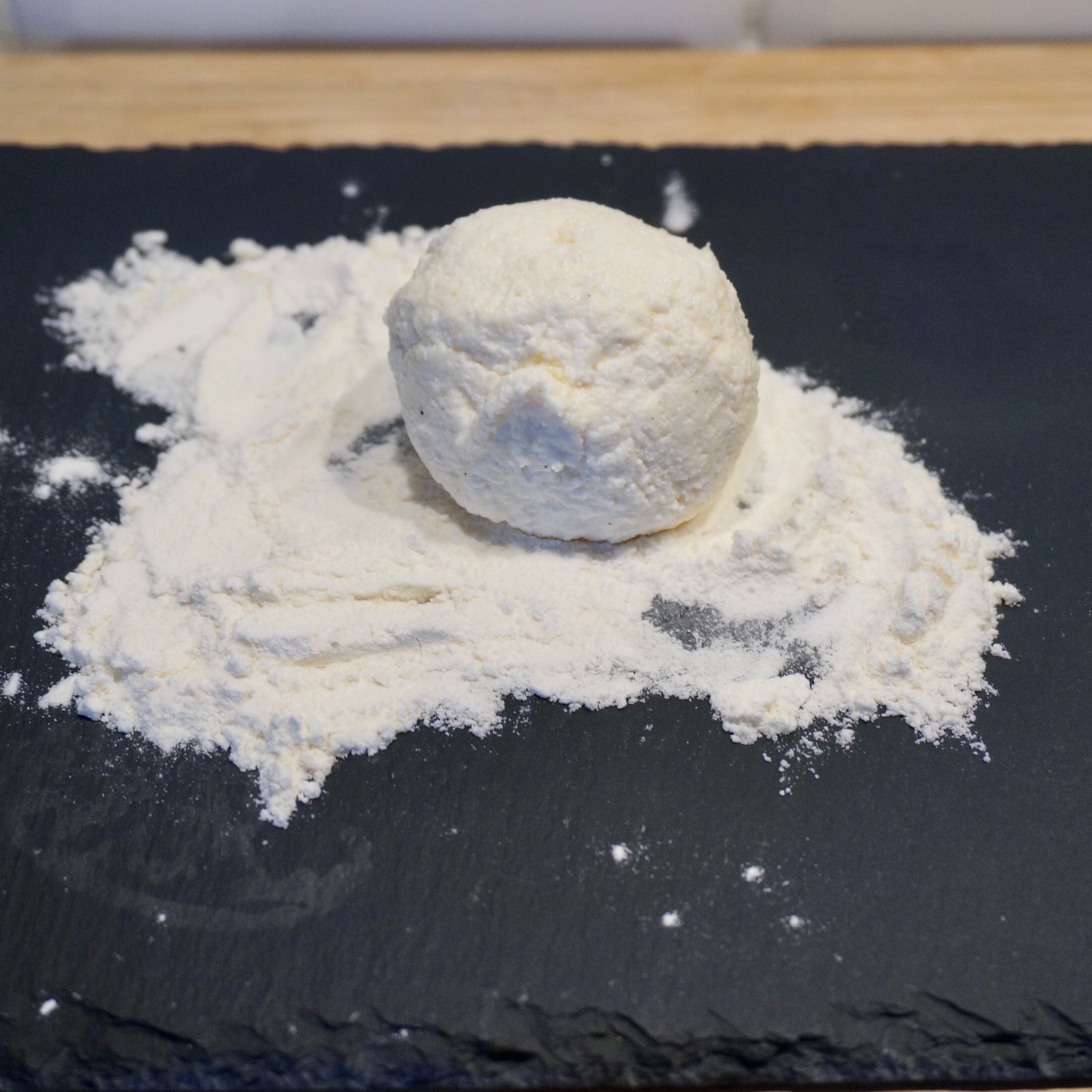 Pour the flour onto a separate plate, make balls from the mixture with your hands, roll in flour.