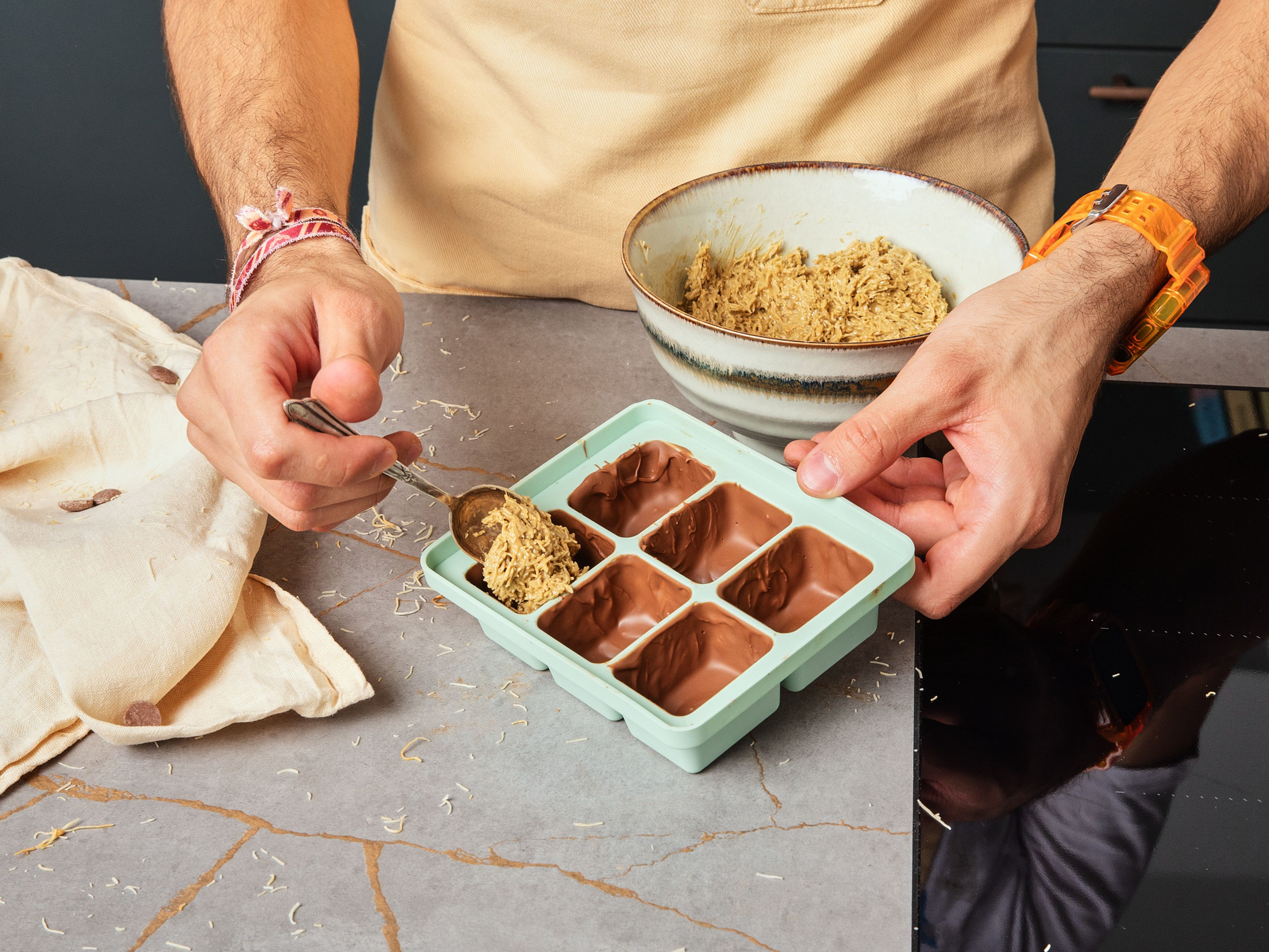 Take the form out and fill each section with the kadayıf mix, leaving some space on top depending on how much chocolate you want. Cover each section with chocolate and refrigerate for approx. 20 min. more. Take the form out the fridge and pop the Dubai chocolate bites out, then serve.