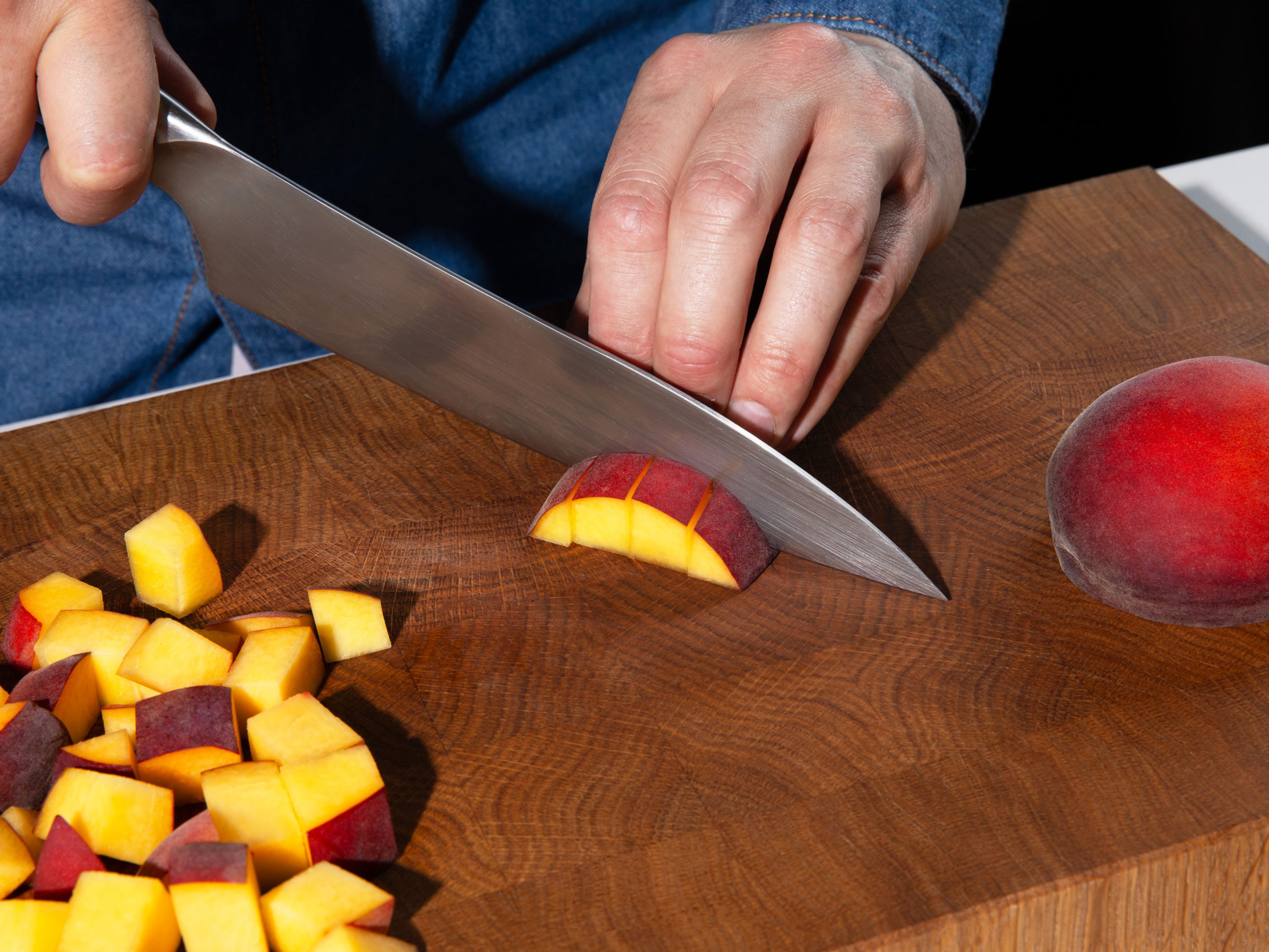 Remove pit and roughly chop most of the peaches. Set aside one peach for garnish and slice into half-moons.