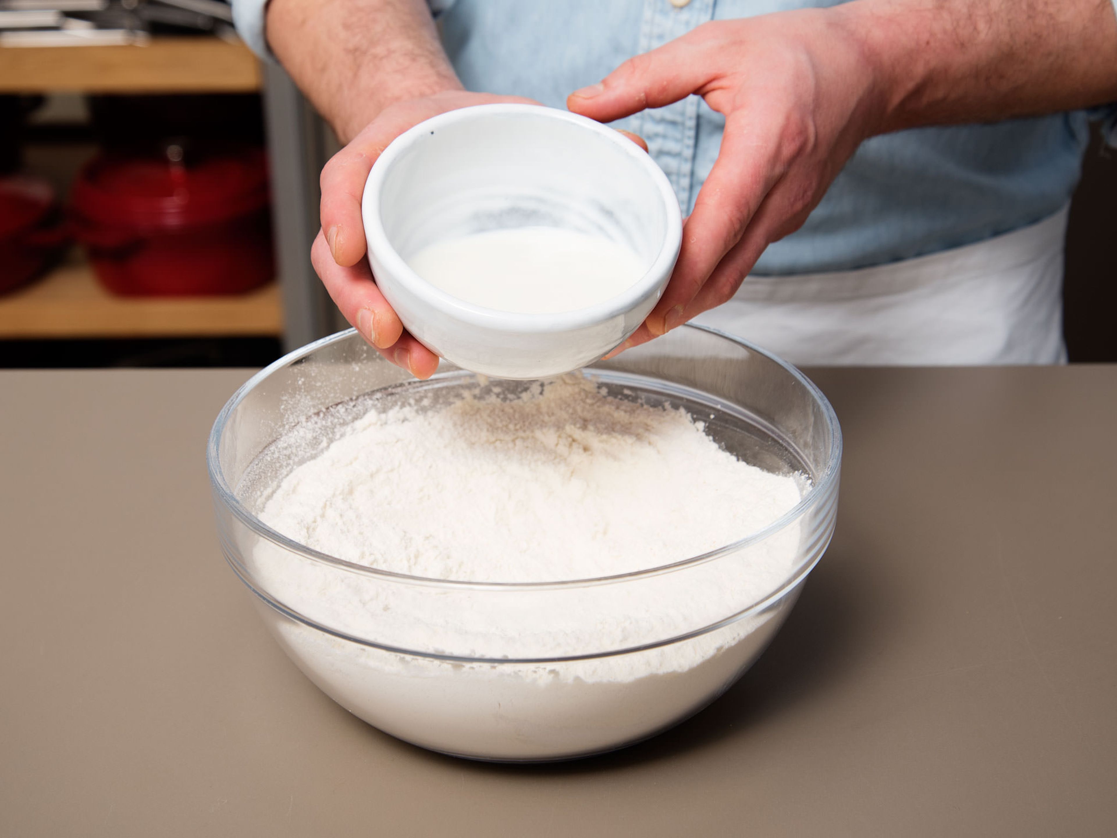 Add flour and sugar to a bowl and stir to combine. Form a small hollow in the middle, add milk and crumble fresh yeast on top. Let rest for approx. 15 min.