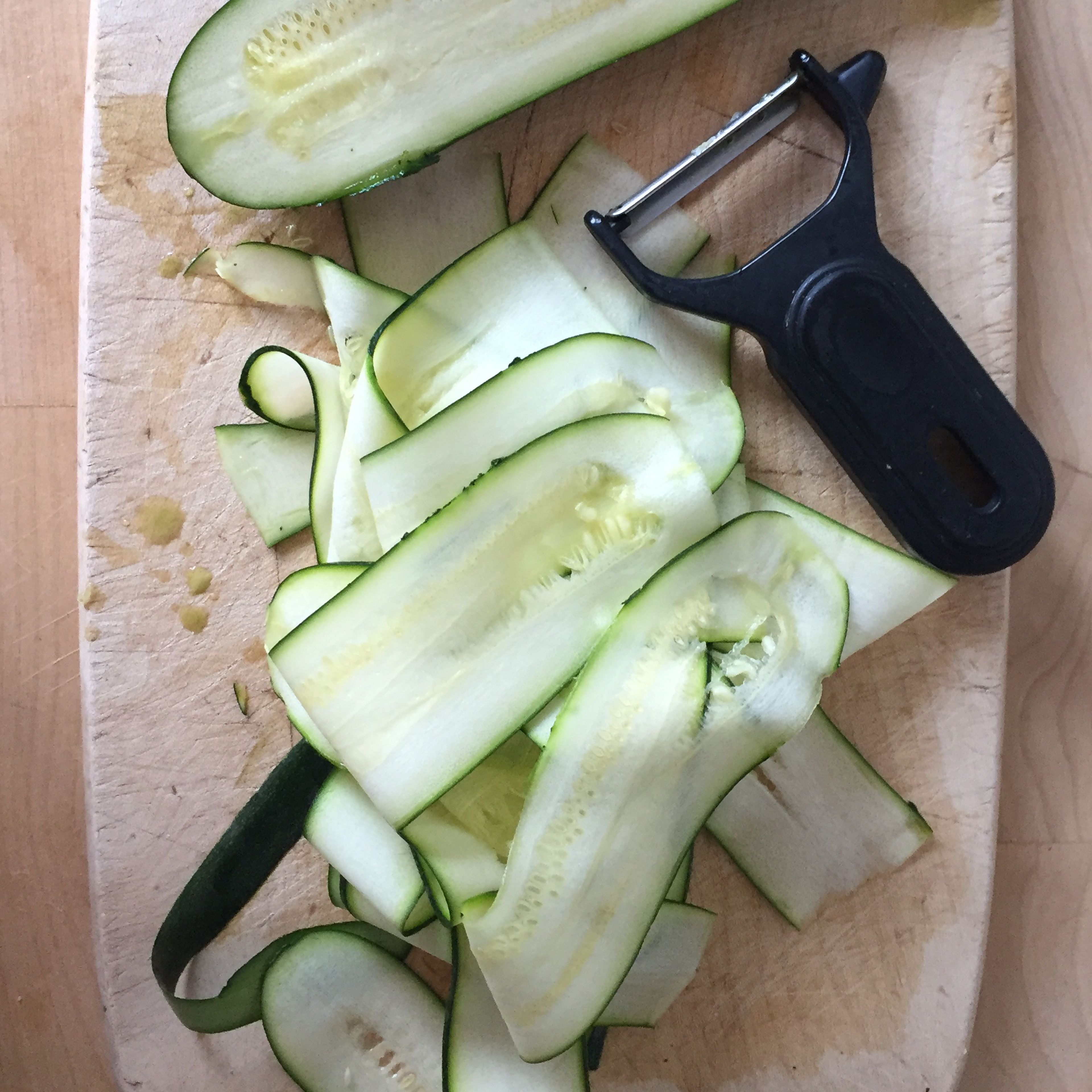Use a vegetable peeler to finely slice the zucchini.