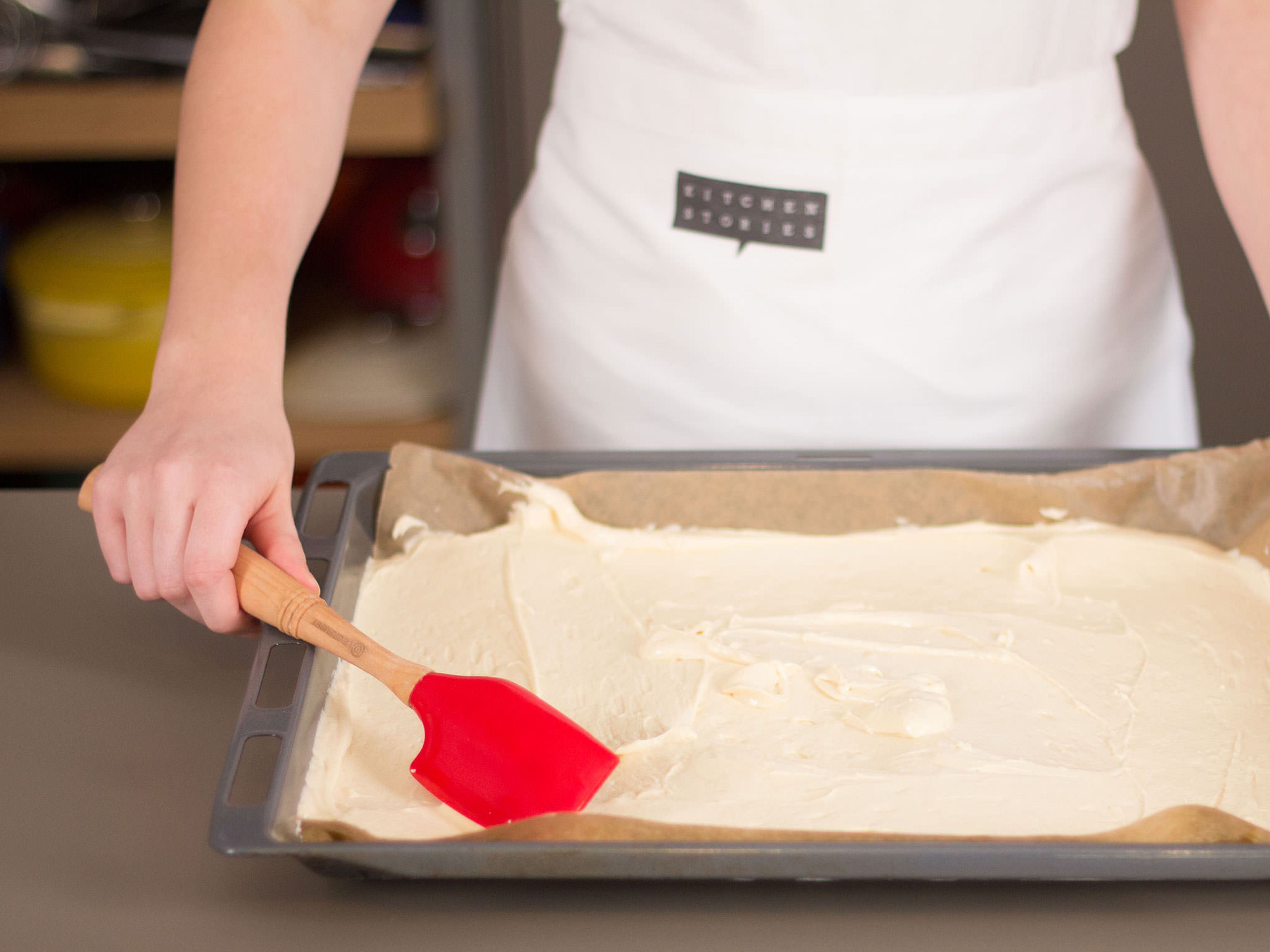 Transfer dough onto a lined baking sheet, spreading it out evenly to create a smooth surface.