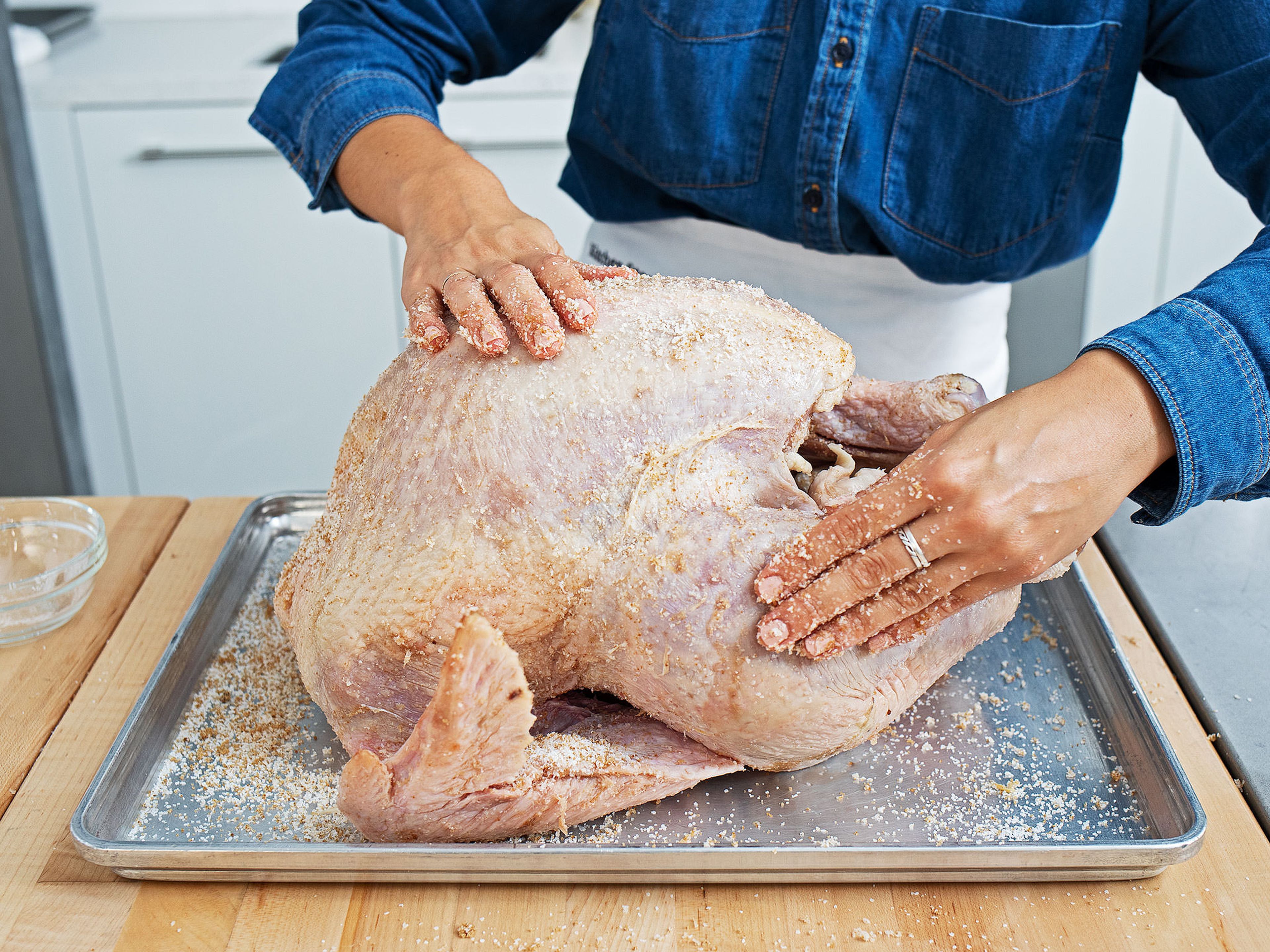 At least 1 day or up to 2 days before serving, brine the turkey. Combine the brown sugar and salt in a small bowl. Place the turkey on a baking sheet and pat dry. Coat thoroughly with the brining mixture. Transfer to the fridge to brine for least 1 or up to 2 days.