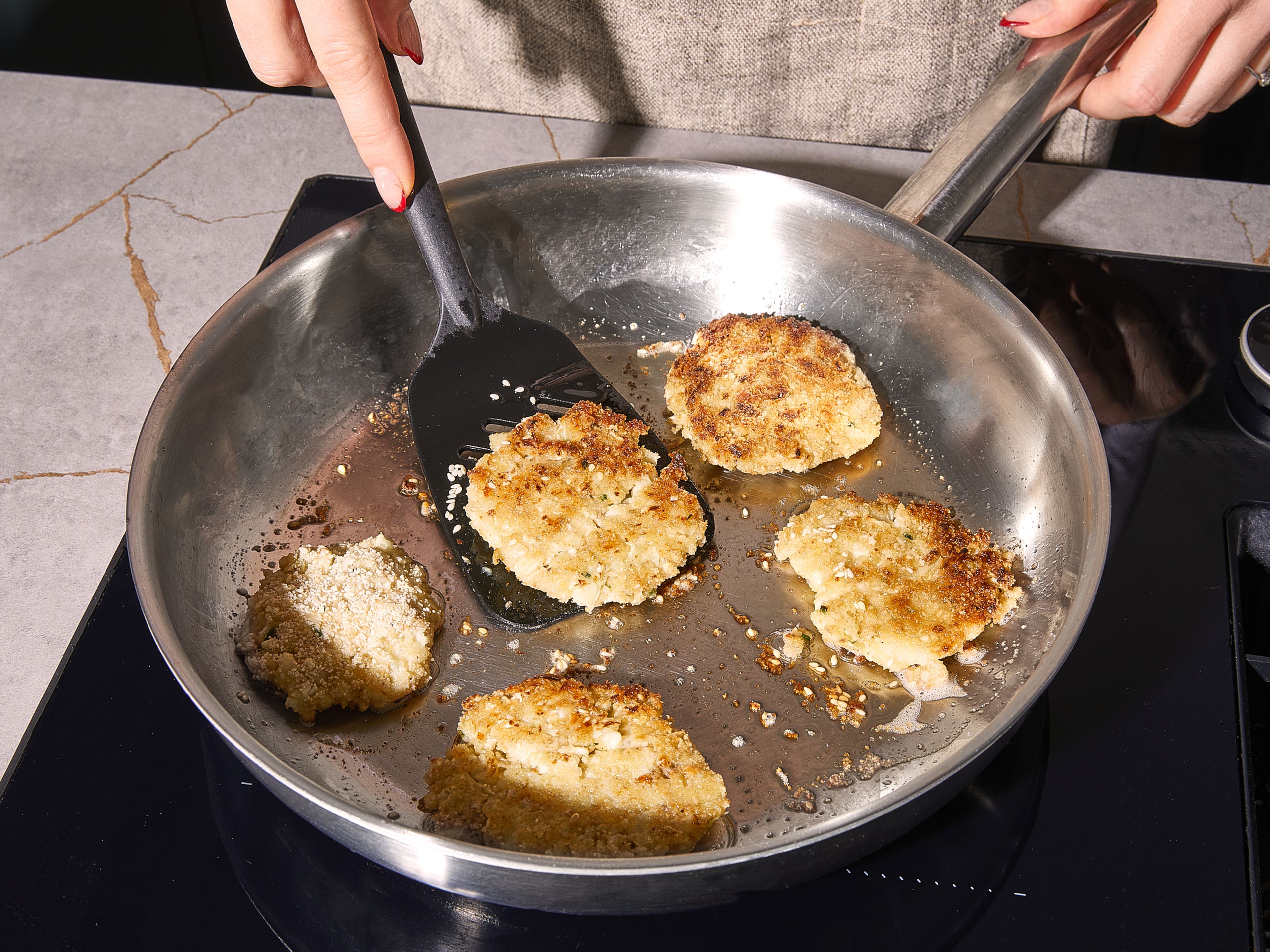 In einer großen Bratpfanne eine dünne Schicht Öl erhitzen. Jede Frikadelle ca. 4 Minuten pro Seite frittieren, bis sie goldbraun und knusprig ist. Dies in Etappen machen, damit die Pfanne nicht zu voll wird. Sofort mit Gurkensalat und Quark-Dip servieren.