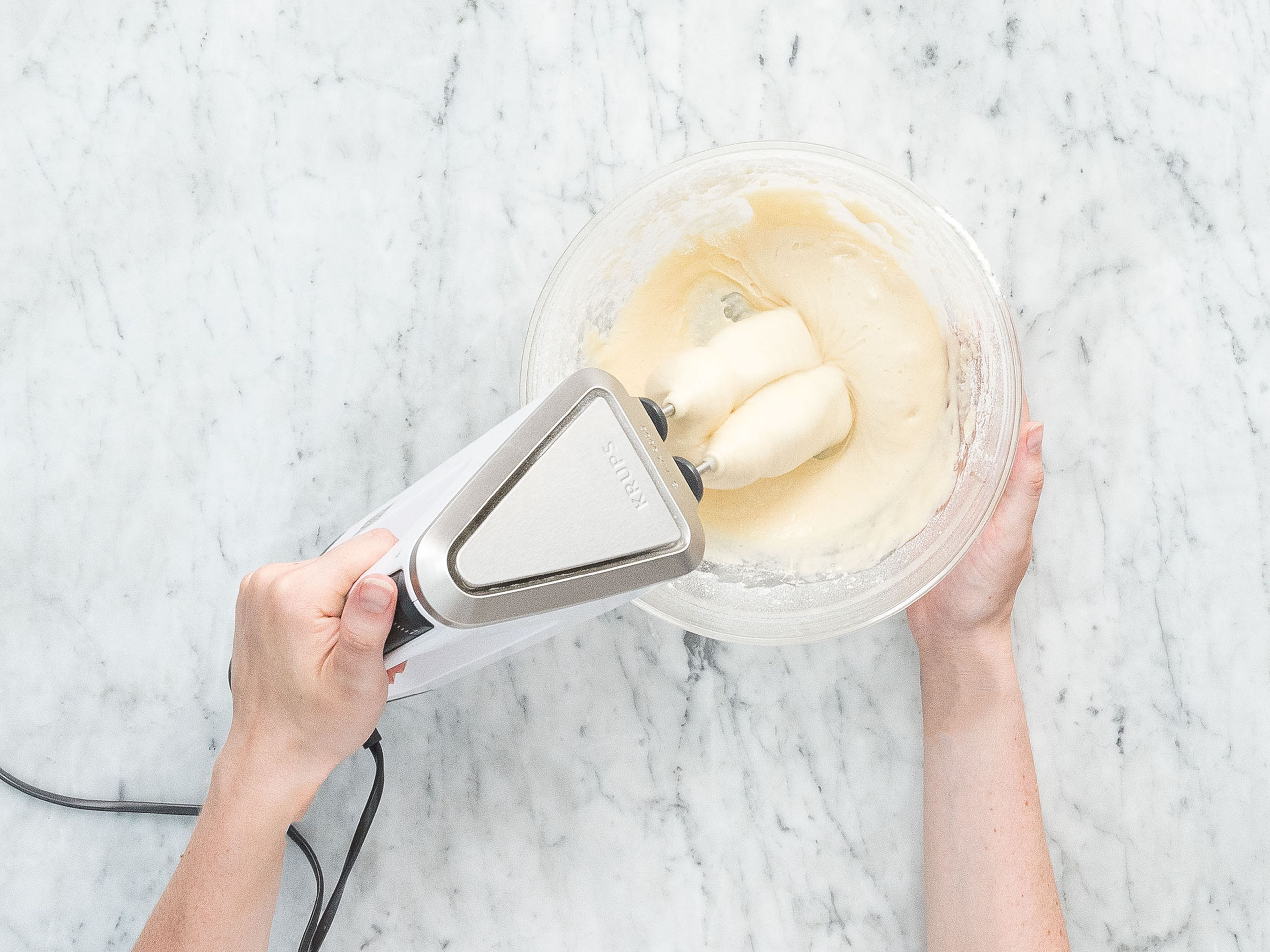 Add flour, baking powder, and baking soda to a bowl. Whisk to combine and set aside. Add eggs, sugar, vanilla sugar, salt, and buttermilk to a separate bowl. Using a hand mixer, beat until combined. Whisk in flour mixture and oil until a smooth batter forms.