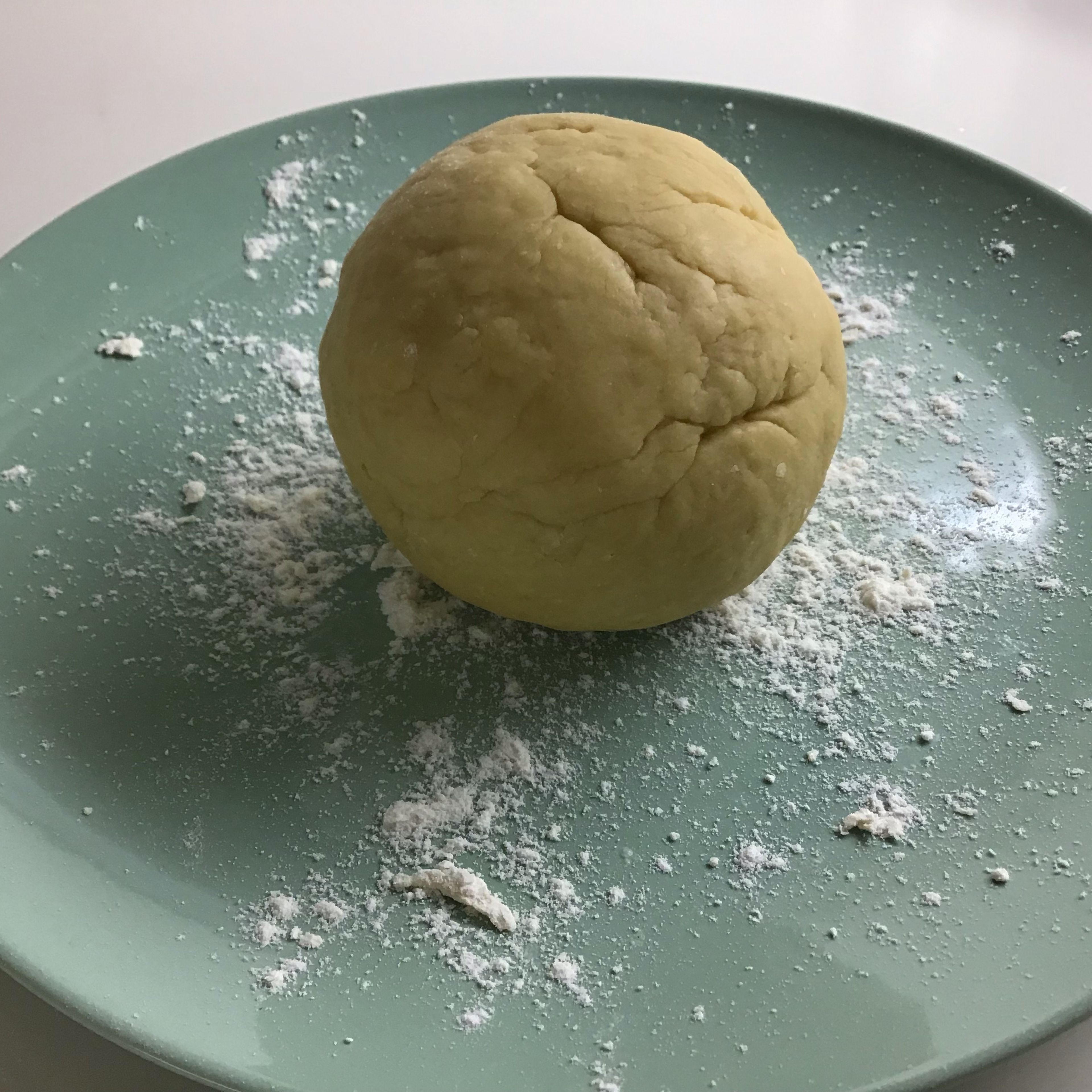 Slowly add 2 cups (1400ml) of flour and mix it with previous step. Then take it out of the bowl and mix(knead). You will need to have a smooth ball.