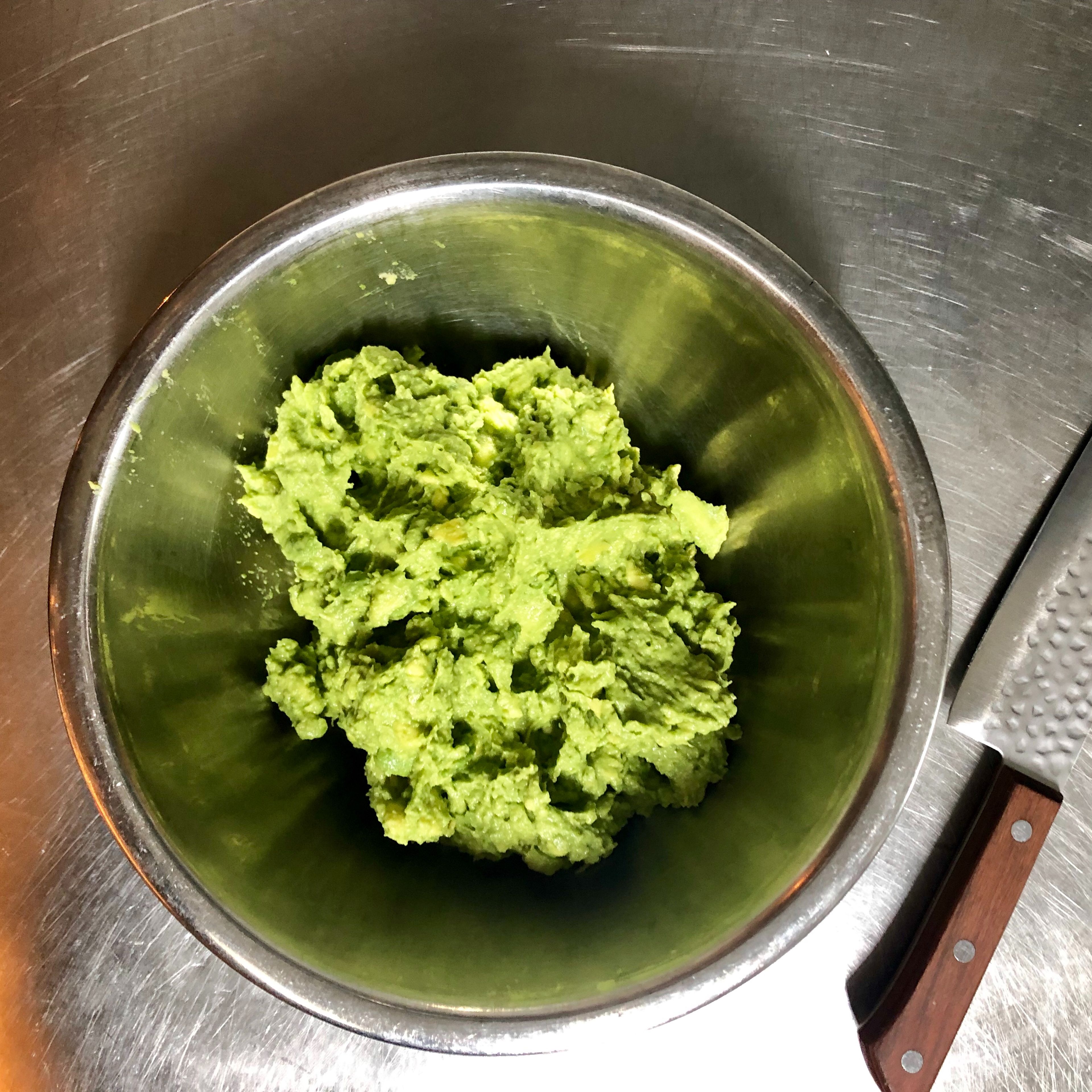 Using a fork, mash the avocado mixture to desired consistency. I like to leave the avocado just a little chunky in the guacamole.