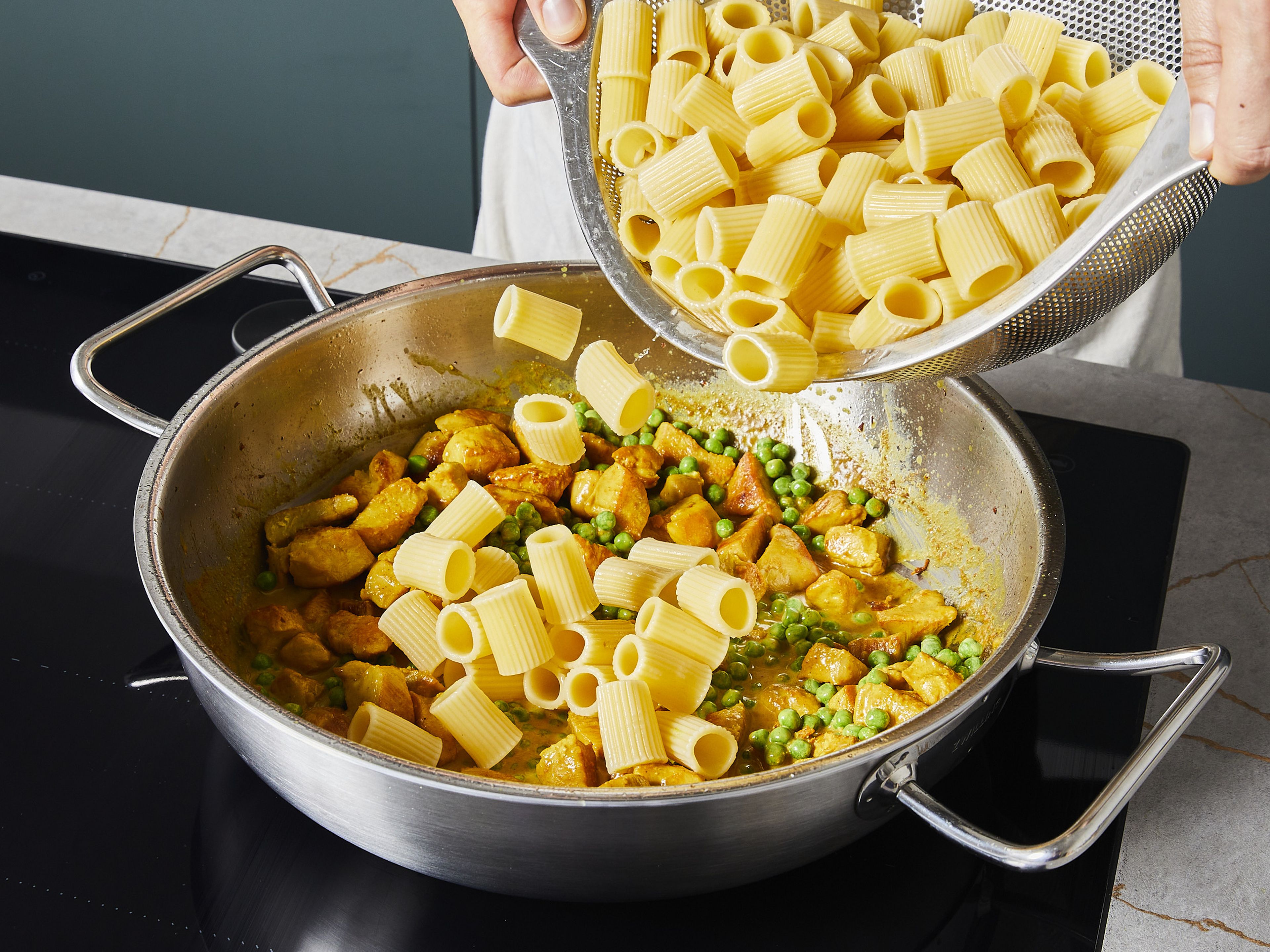 Add cooked pasta and mix thoroughly until everything looks glossy and creamy. Serve the finished pasta on deep plates.