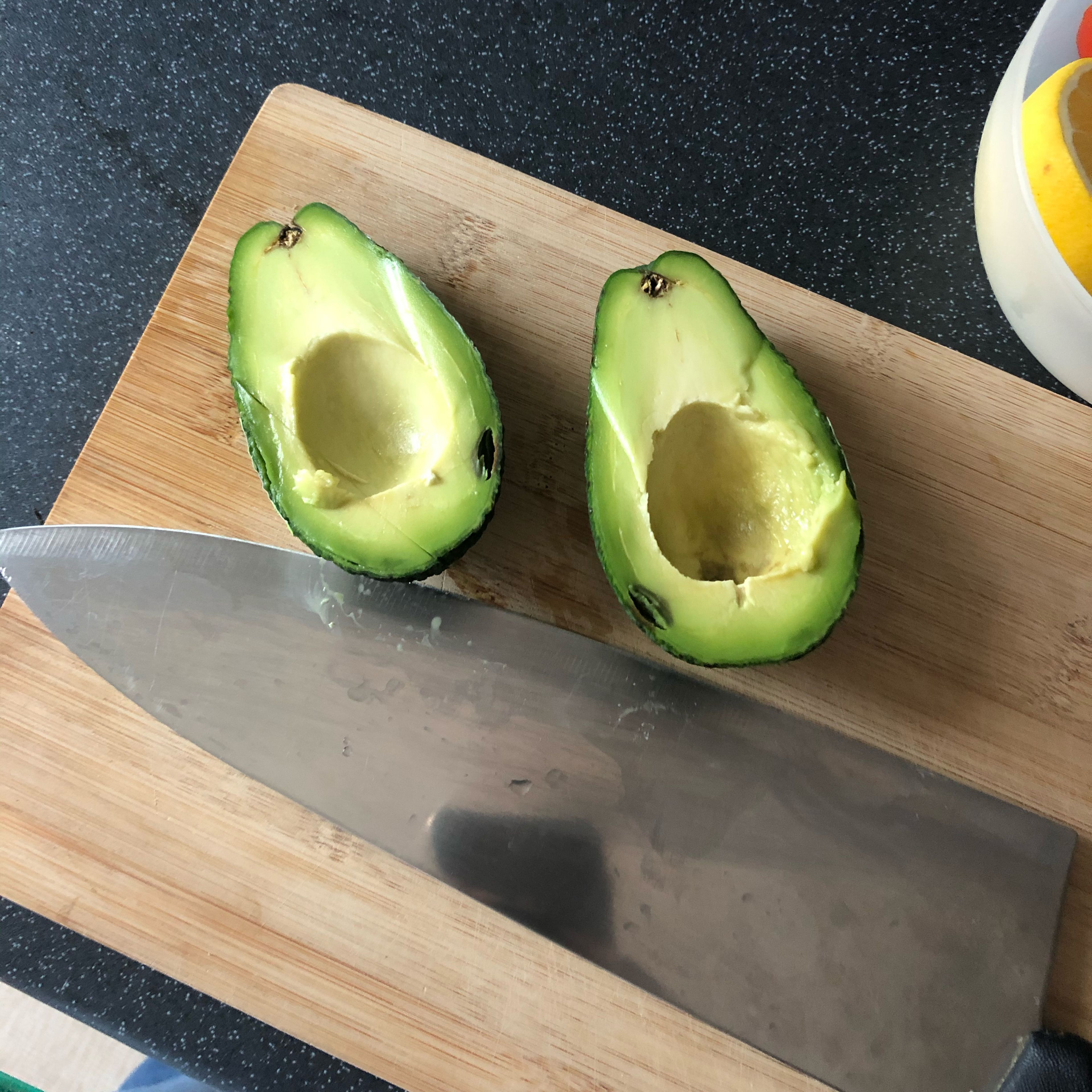 In a meanwhile, cut the avocado in half and scoop out. Place in blender.