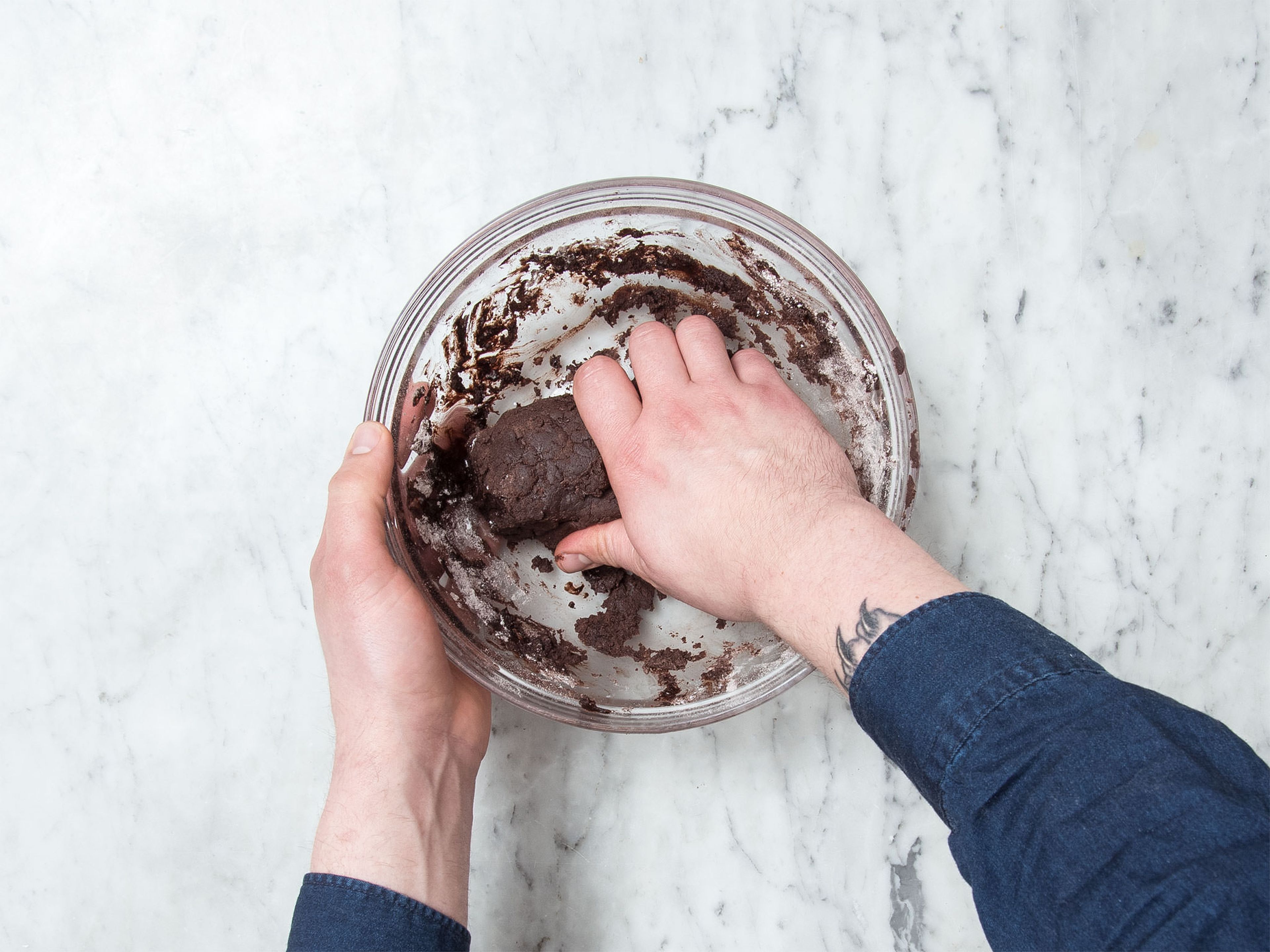 In a large bowl beat butter until creamy, approx. 1 min with the hand mixer with beaters. Gradually add in confectioner’s sugar, cocoa, vanilla extract, and salt. Add flour and knead using your hands until dough is smooth.