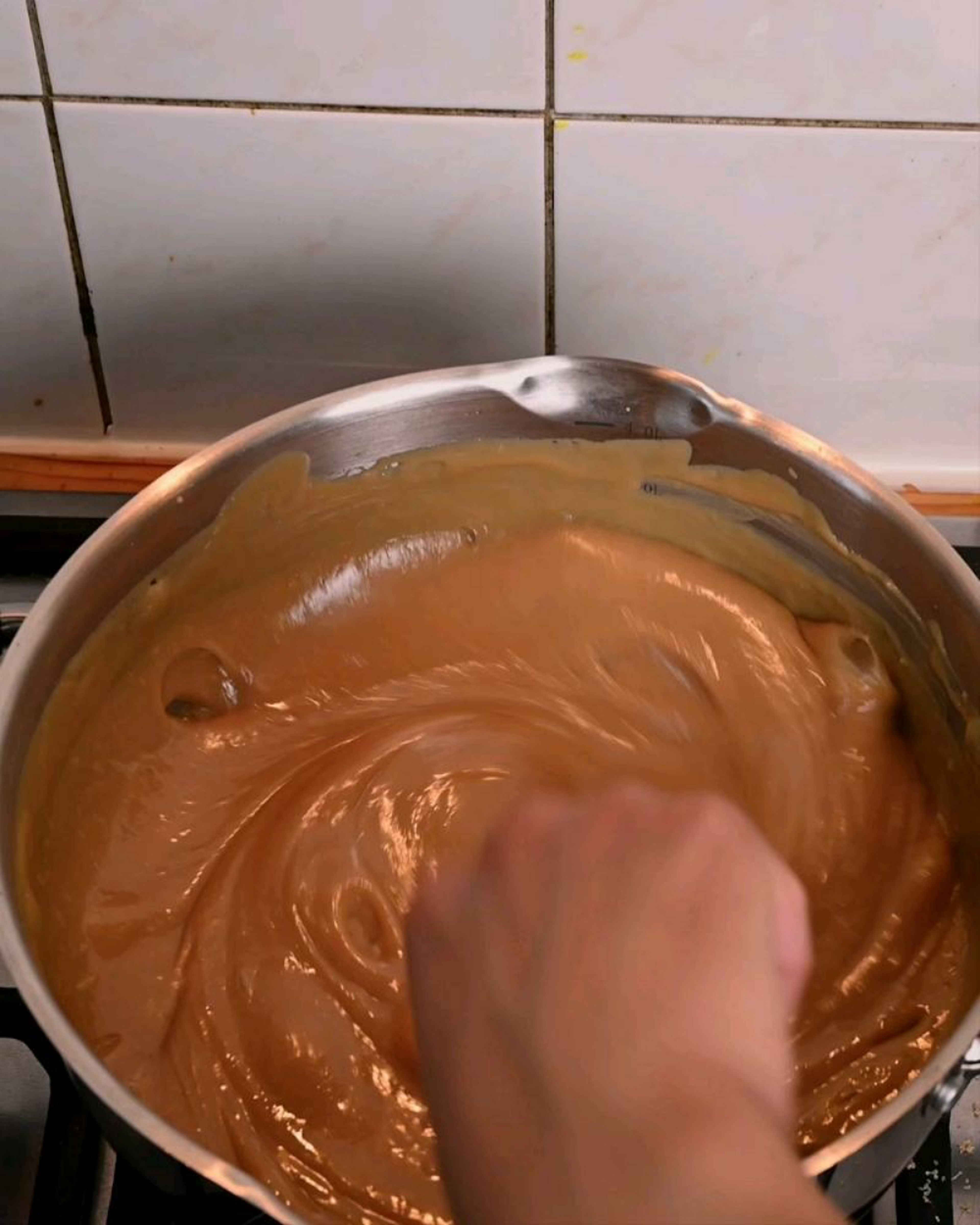 In adding the vanilla extract, ensure that all of the sugar has been added and is well combined with the condensed milk.