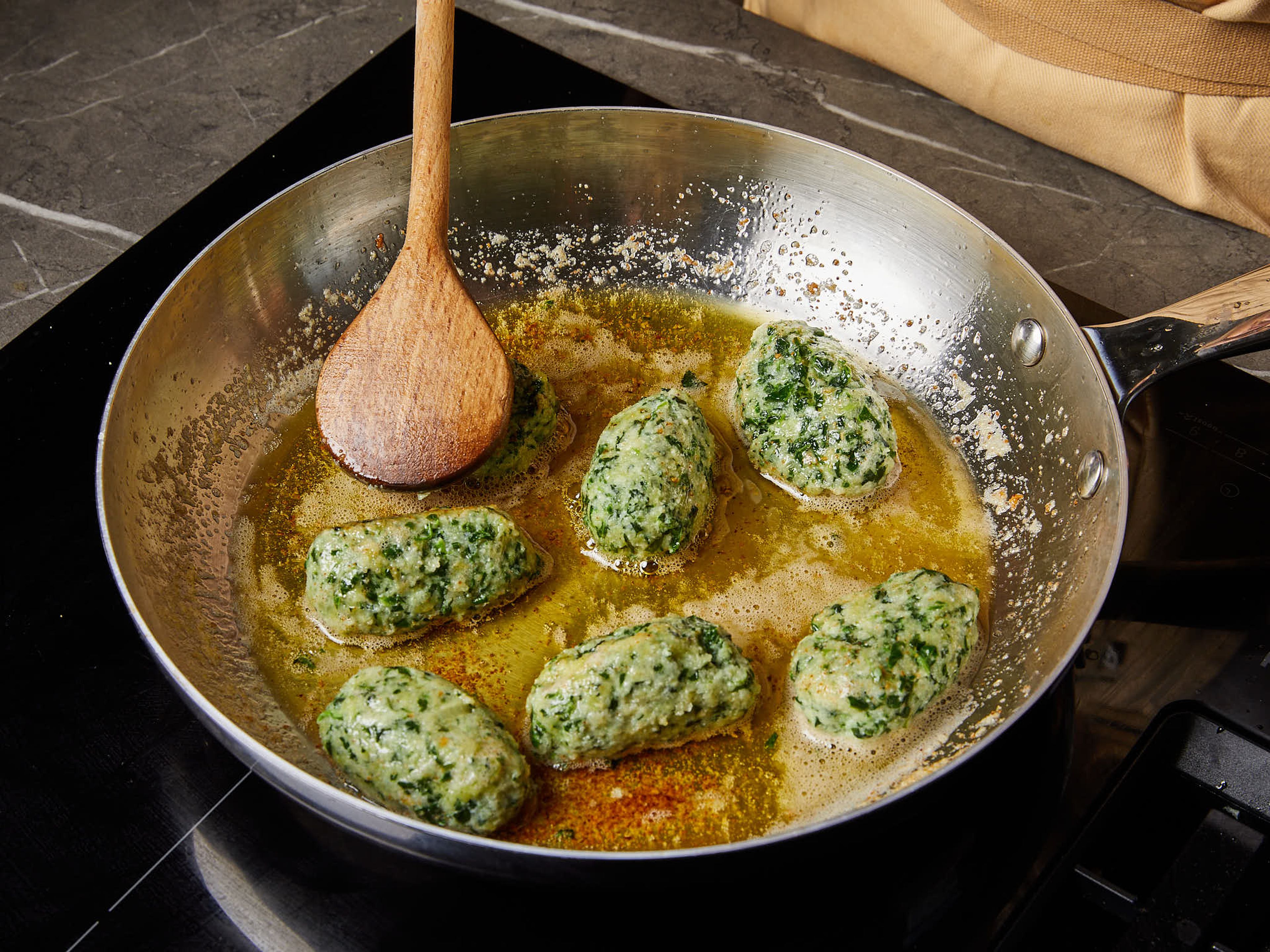 Melt the remaining butter in a pan to brown lightly. Add the malfatti an toss in the brown butter. Serve with the butter, grate the remaining Parmesan over, some lemon zest and fresh pepper.