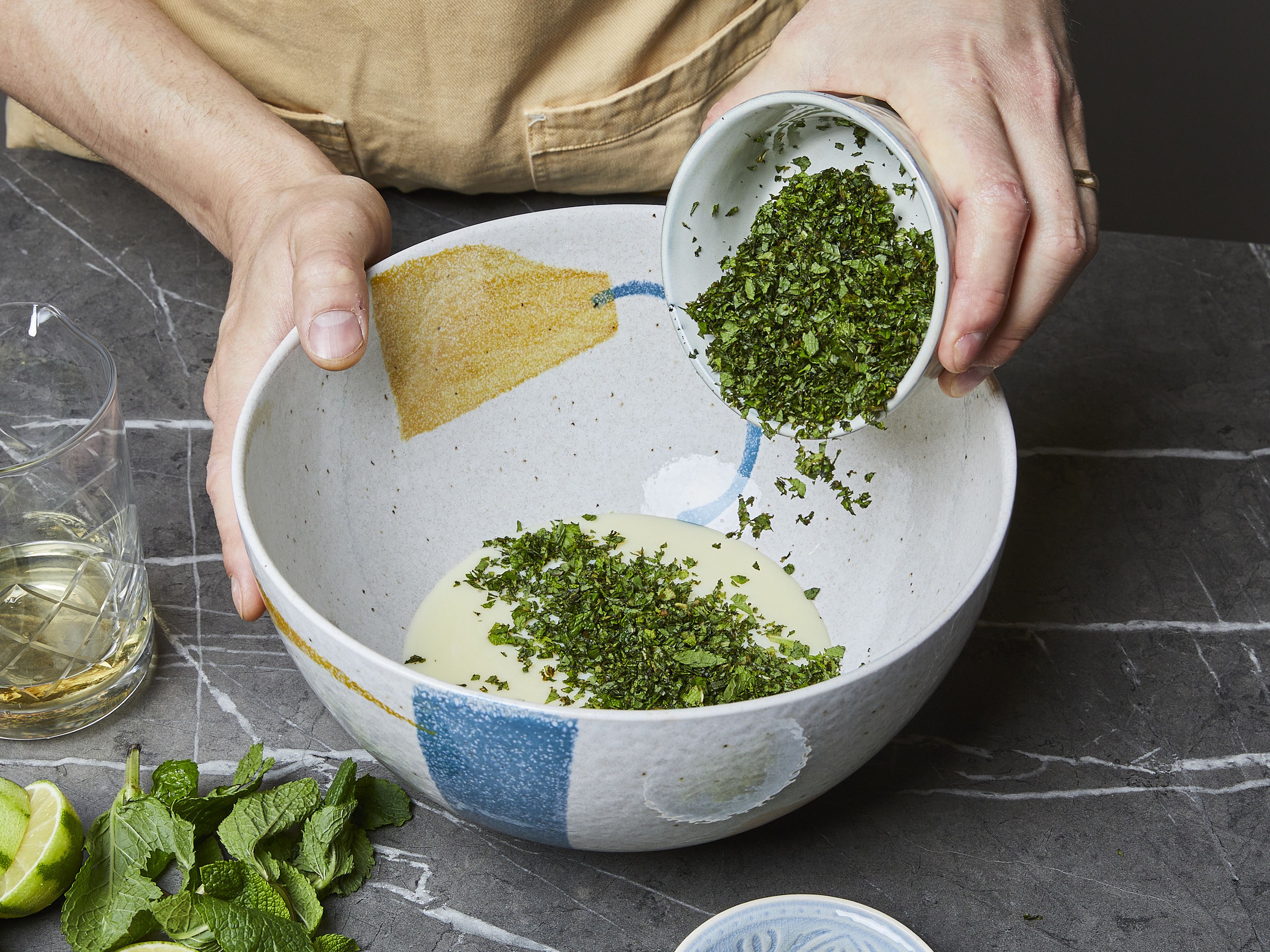 Place the whipping cream in a large mixing bowl and beat with a hand mixer with beaters on high speed until stiff peaks form when the mixer is pulled out. In a separate large bowl, mix together the sweetened condensed milk, chopped mint, rum, lime zest, and lime juice.