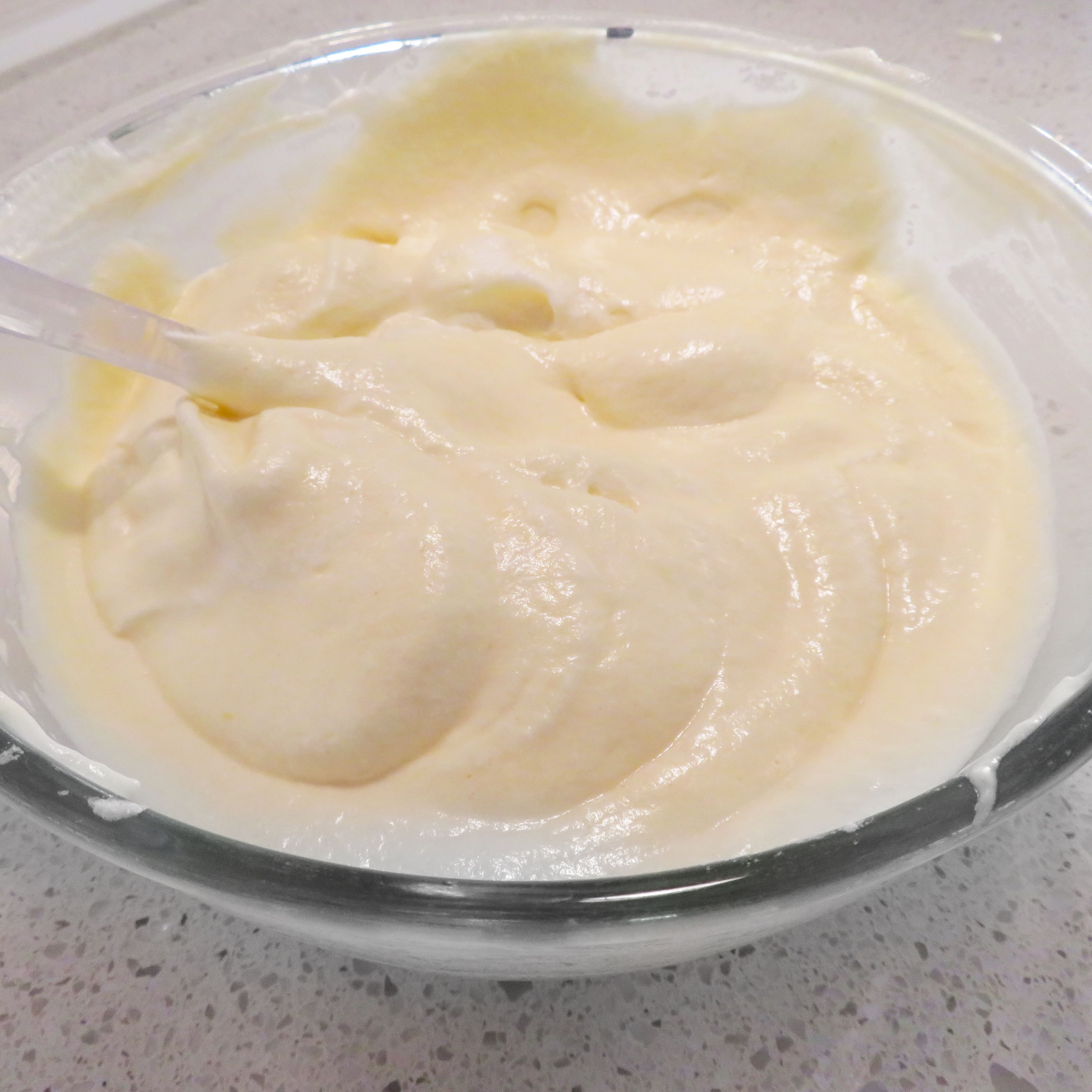 Slowly fold egg white into the mixture until light and fluffy.