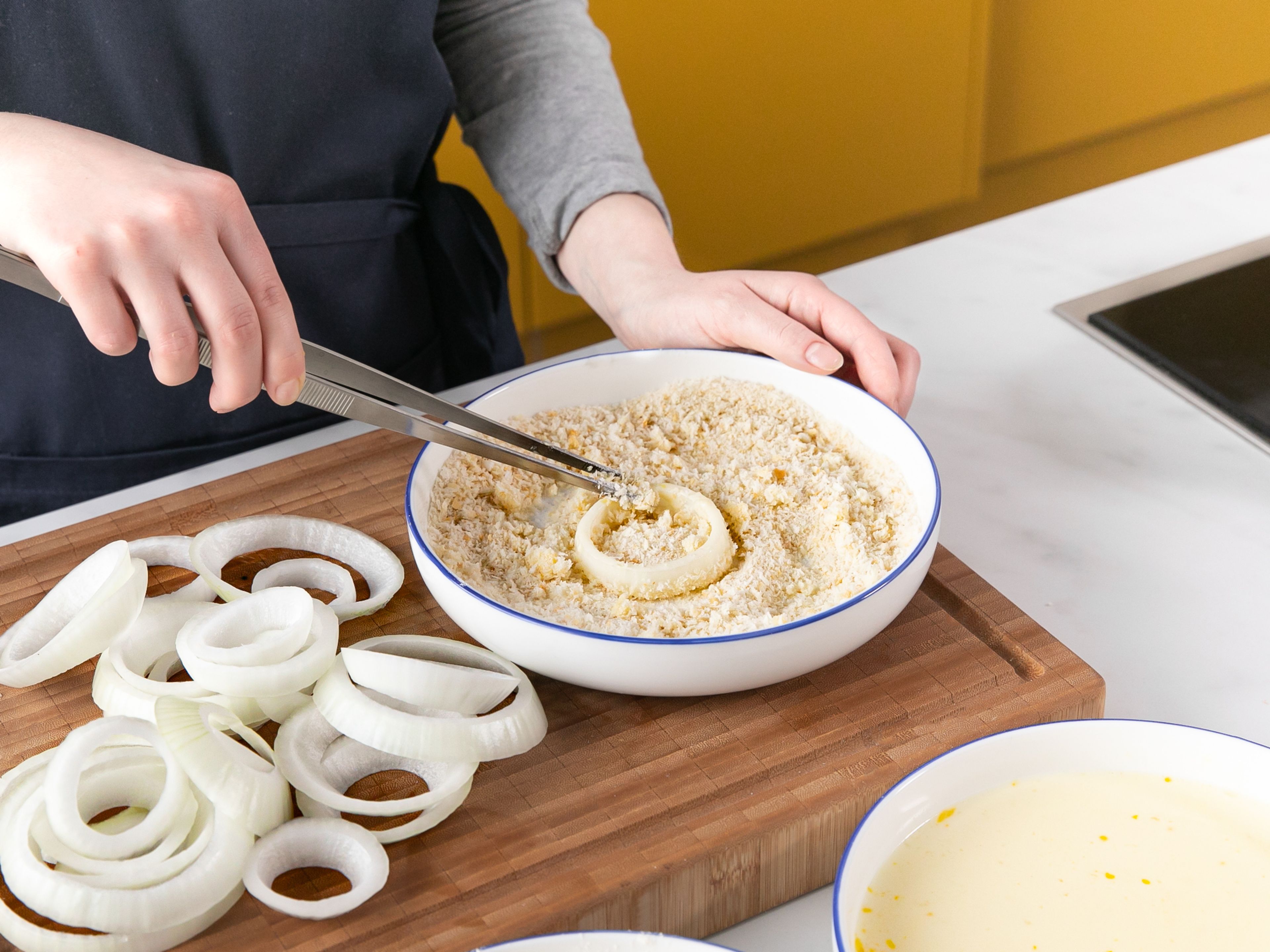 Dip onion rings into the flour mixture, shaking off the excess. Then dip into the egg mixture, shake off the excess, and coat all over in breadcrumbs. Transfer to a baking sheet and repeat with all onion rings.