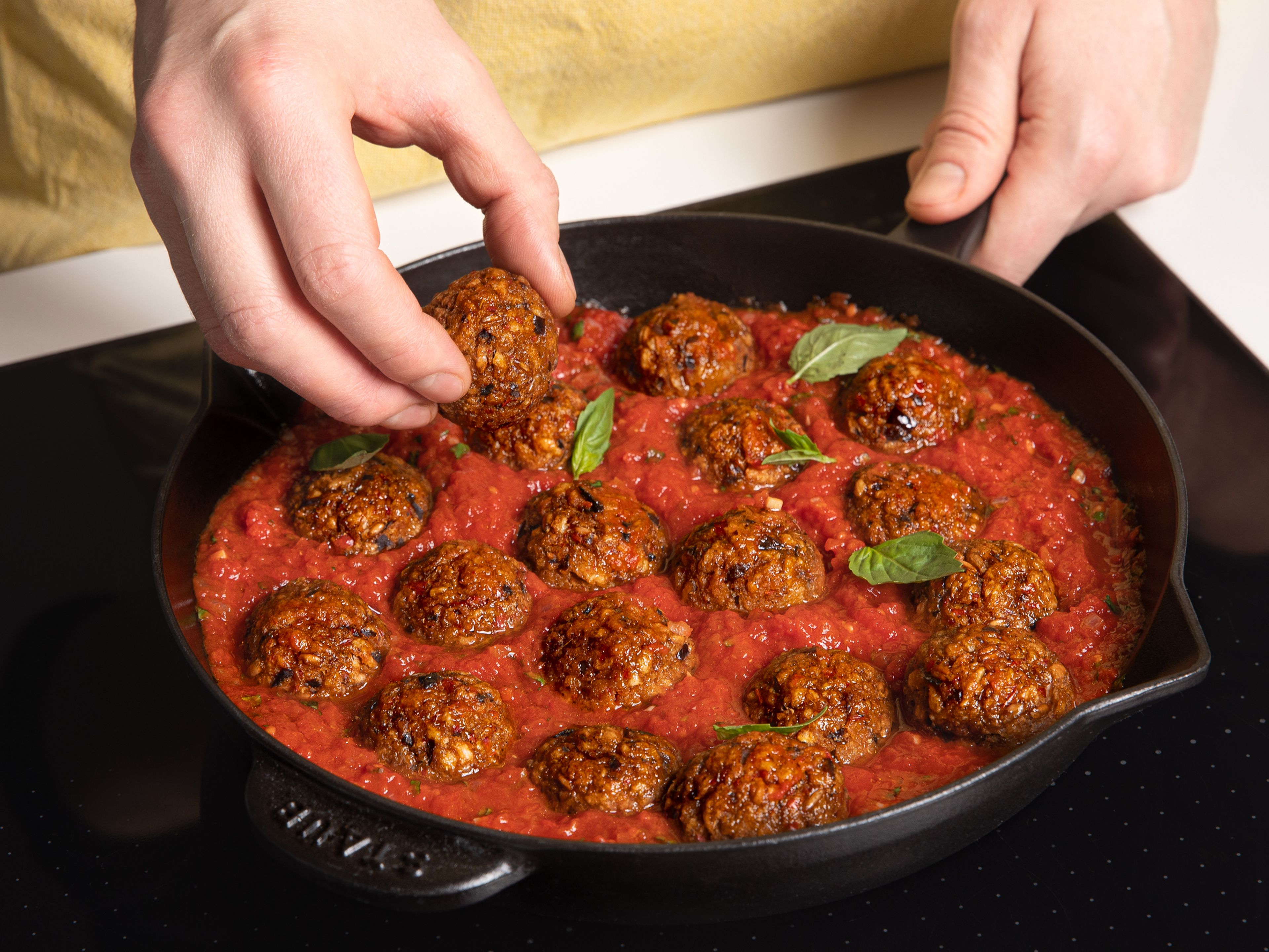 Bake at 200°C/400°F for approx. 20 min. or until lightly browned and crisp on the outside. Add half of the basil leaves to the tomato sauce, then add the meatballs and lightly toss. Serve with remaining basil and enjoy!