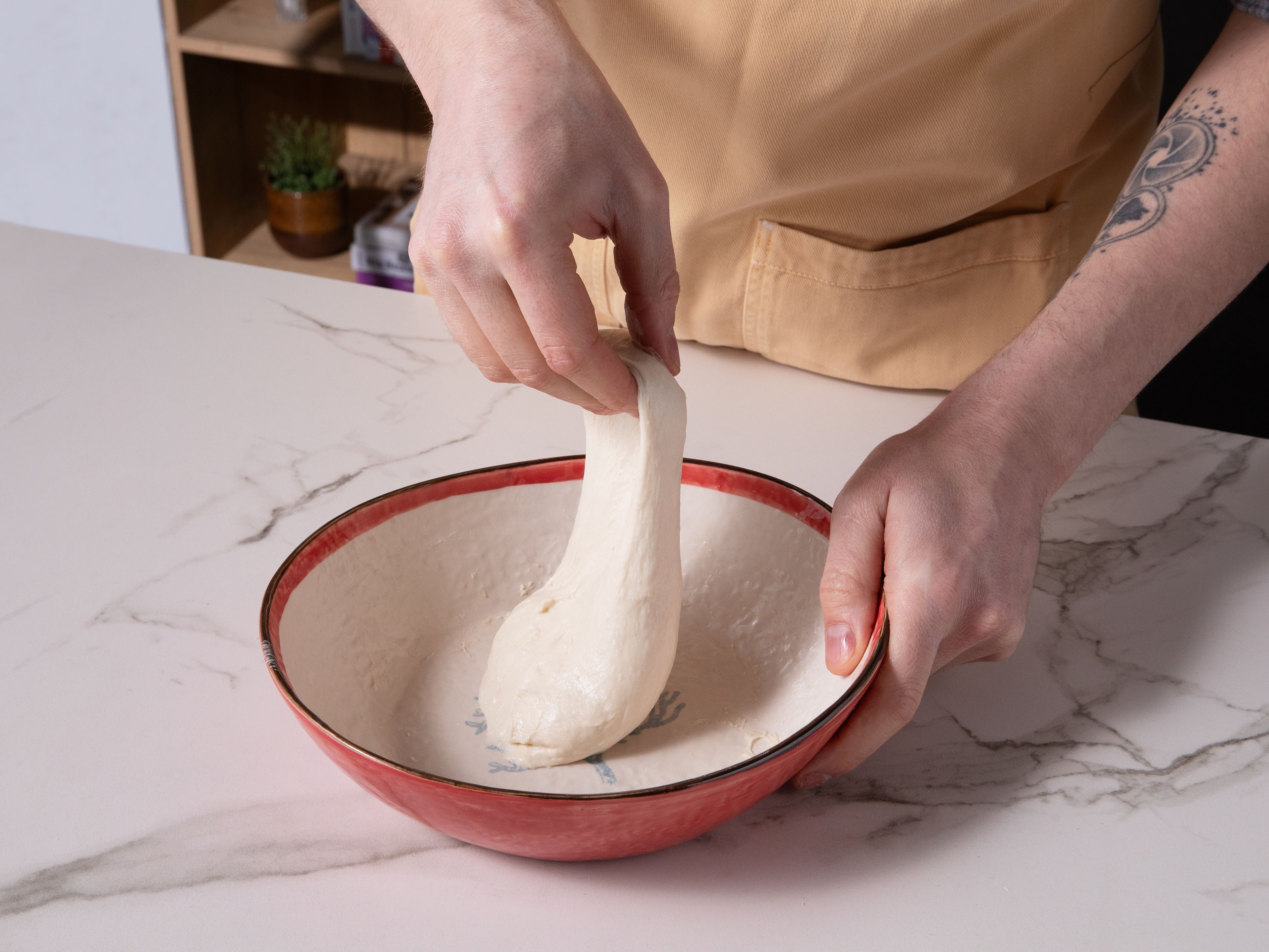 Next, fold the dough twice, at 30 min. intervals. To fold it, oil your fingers, and gently lift the dough, stretch it slightly, and fold under itself. Repeat from all sides for extra tension and better structure in the dough.
