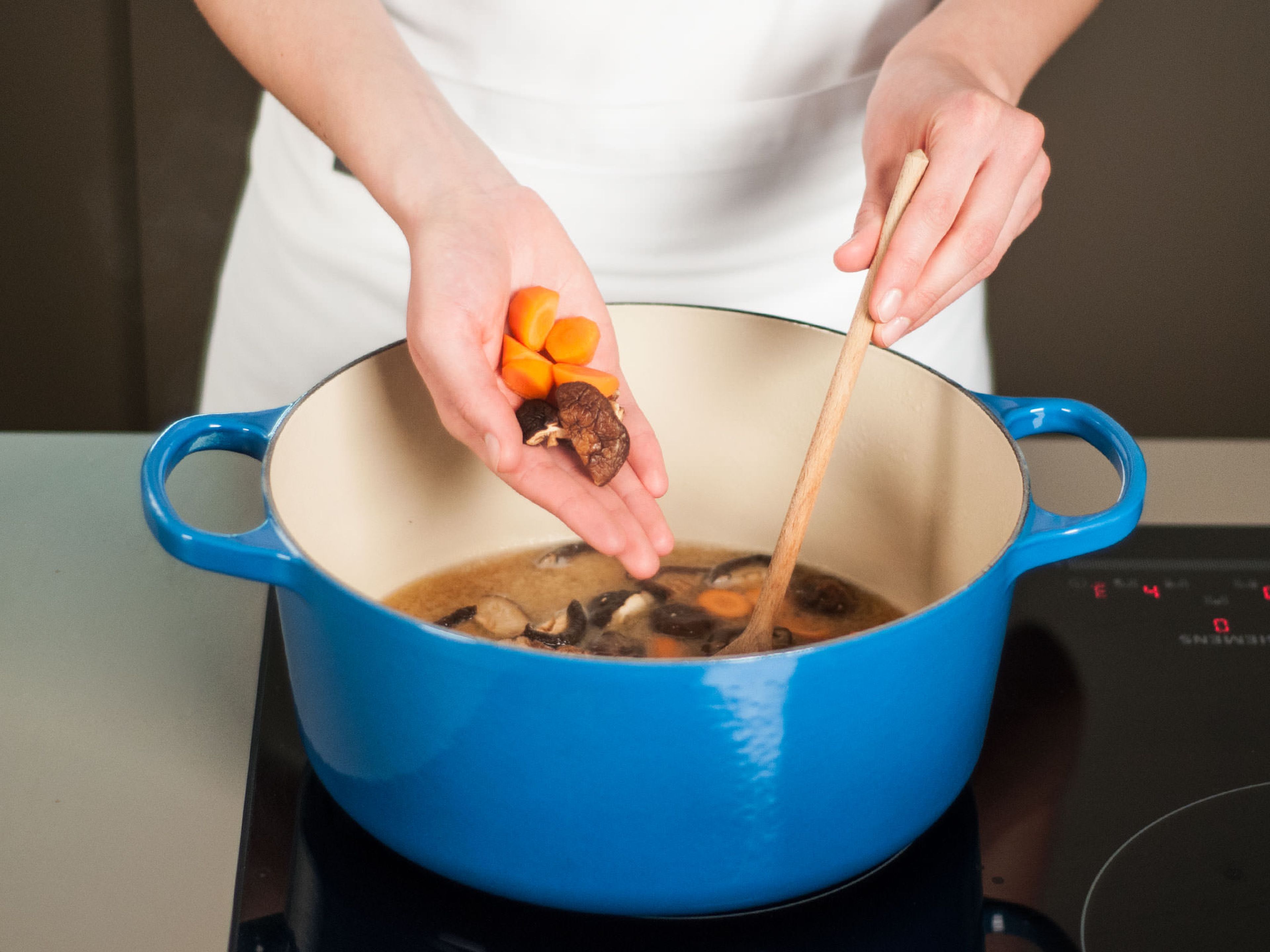 Geschnittene Pilze und Karotten hinzugeben und ca. 5 Min. kochen.