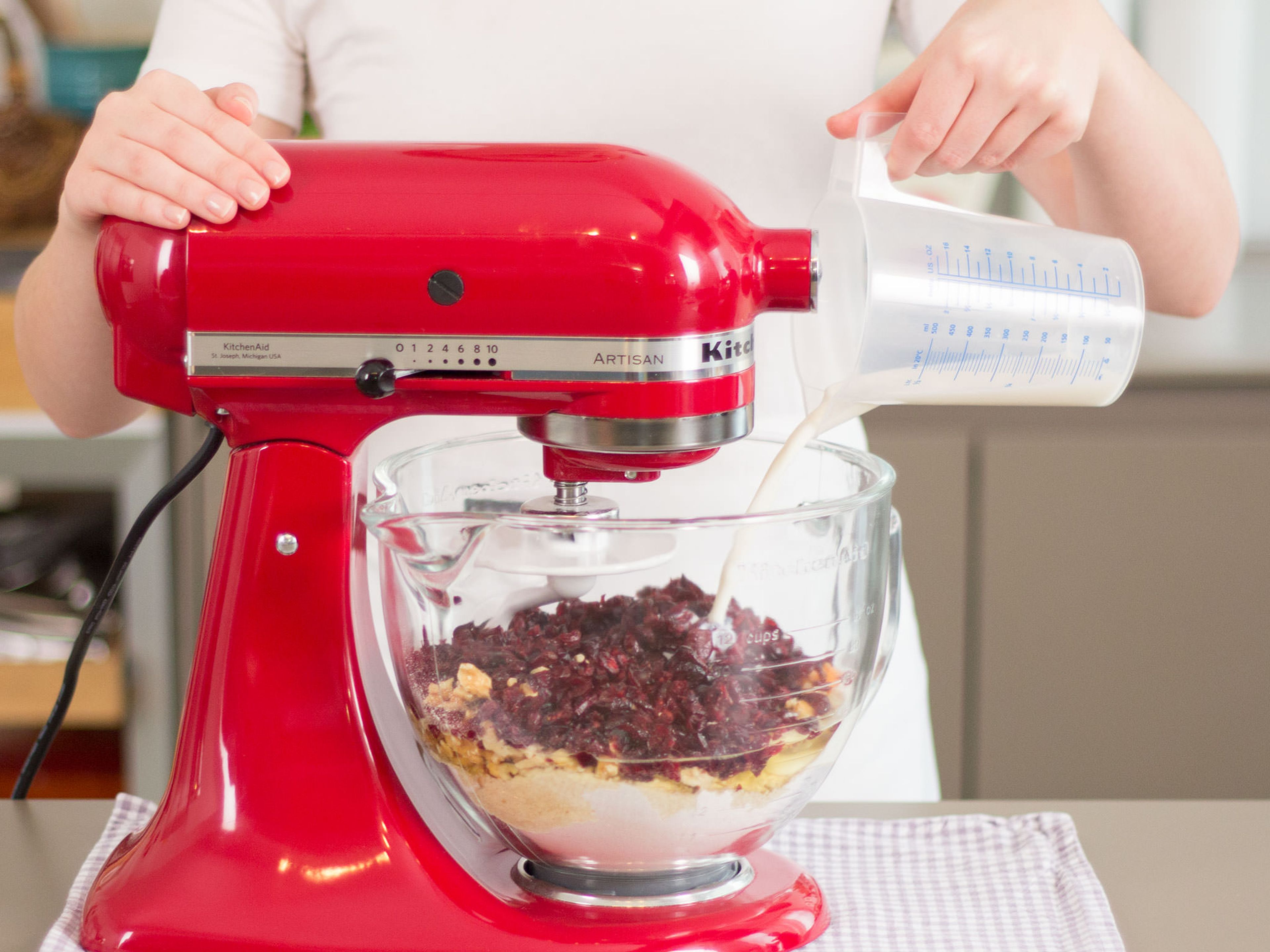 Add flour, baking powder, walnuts, cranberries, yogurt, eggs, salt, and milk to a stand mixer. Beat for approx. 2 – 3 min. until a smooth dough forms.