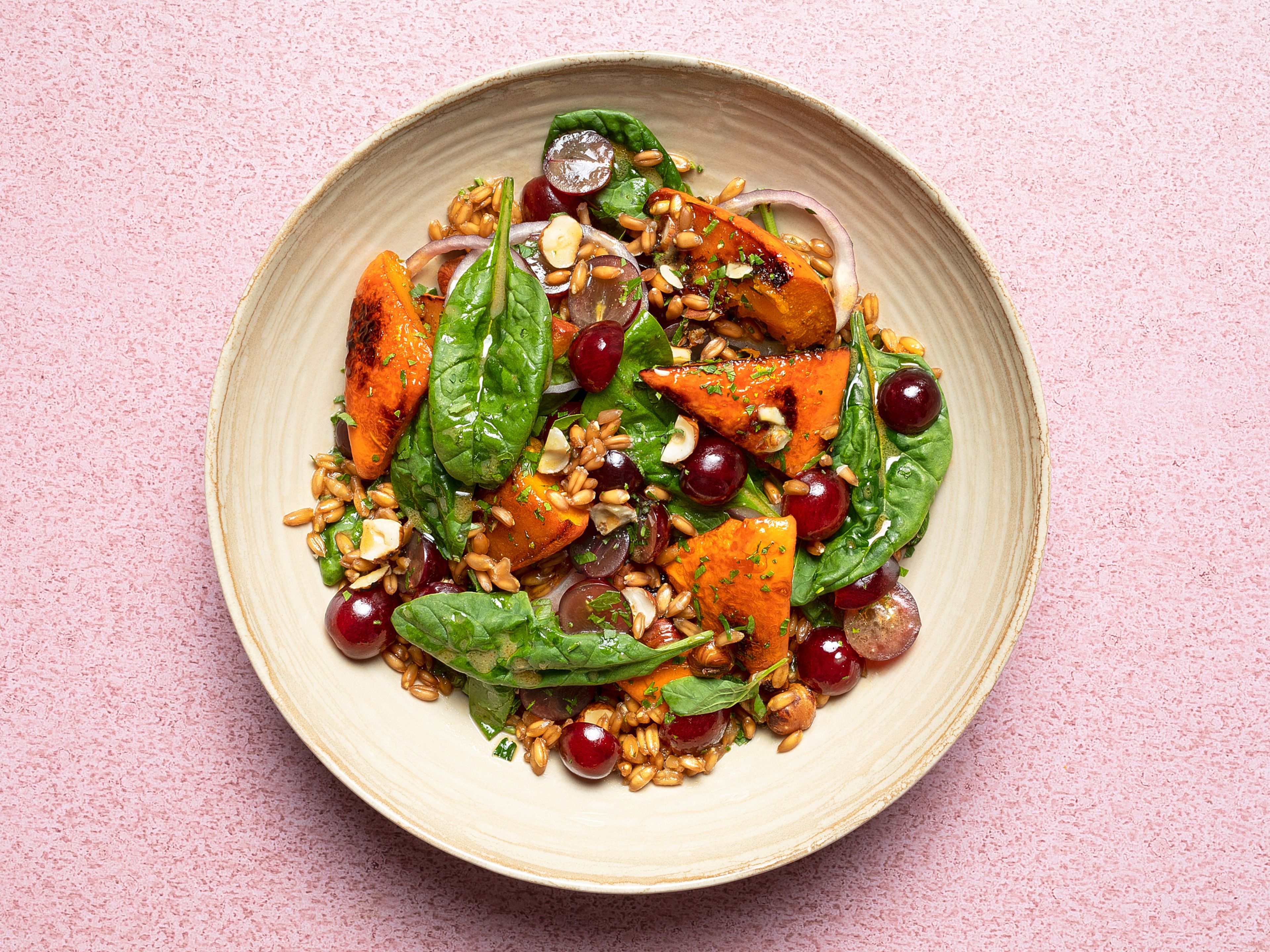 Spelt salad with pumpkin, grapes, and hazelnuts