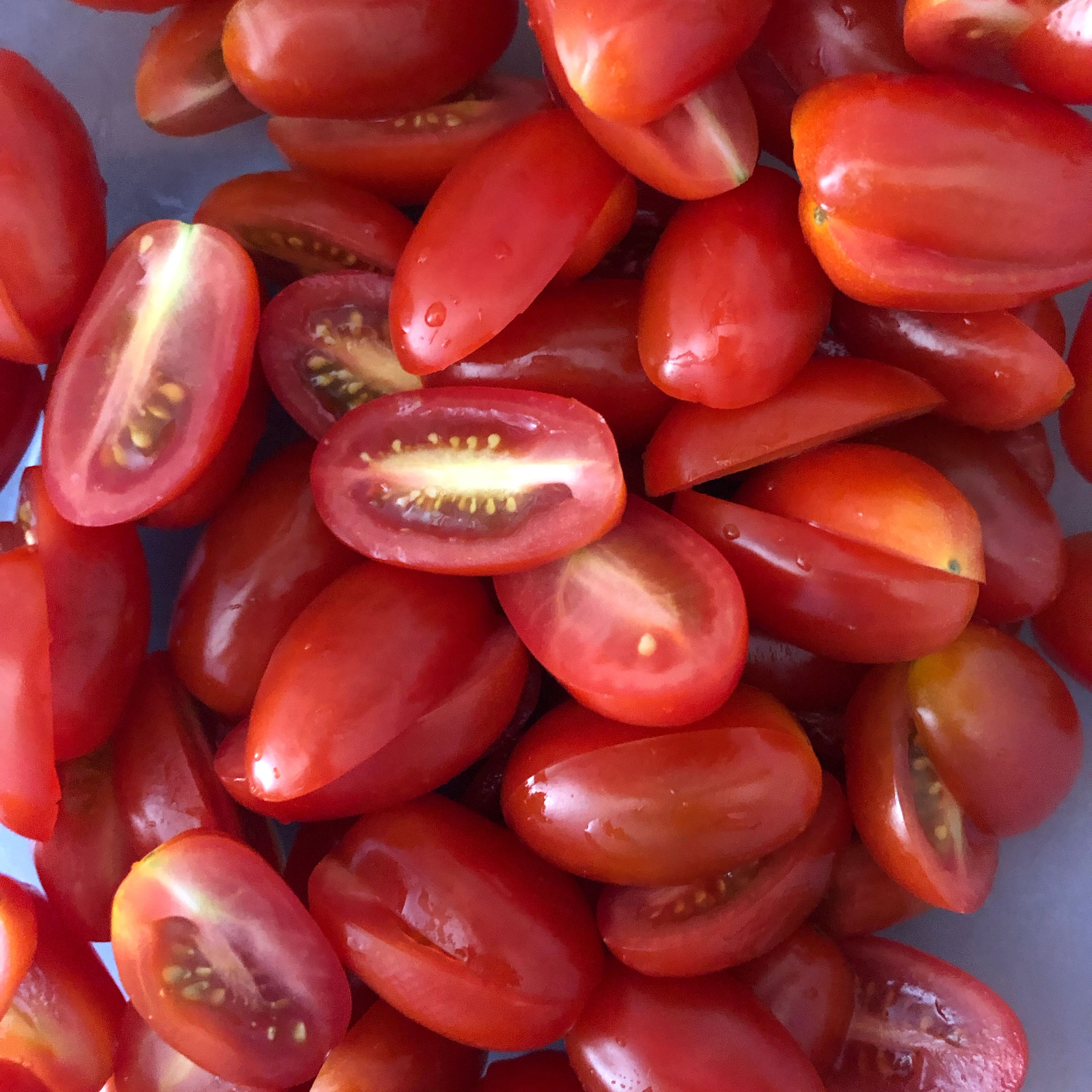 Wash and cut cherry tomatoes into halves or quarters.