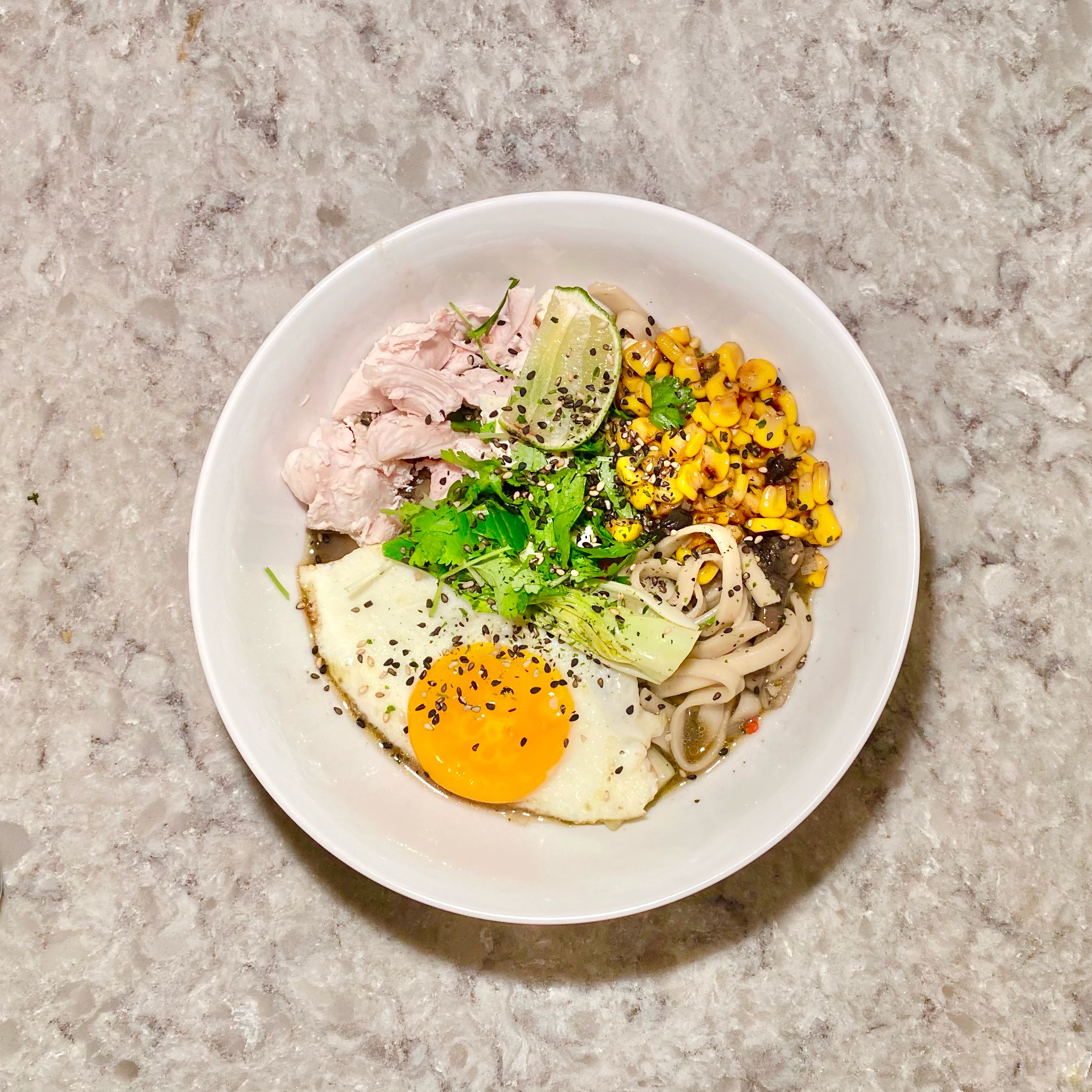 Serve the soup in a deep bowl. Add the corn on top along with chopped fresh cilantro, an poached or fried egg and furikake.