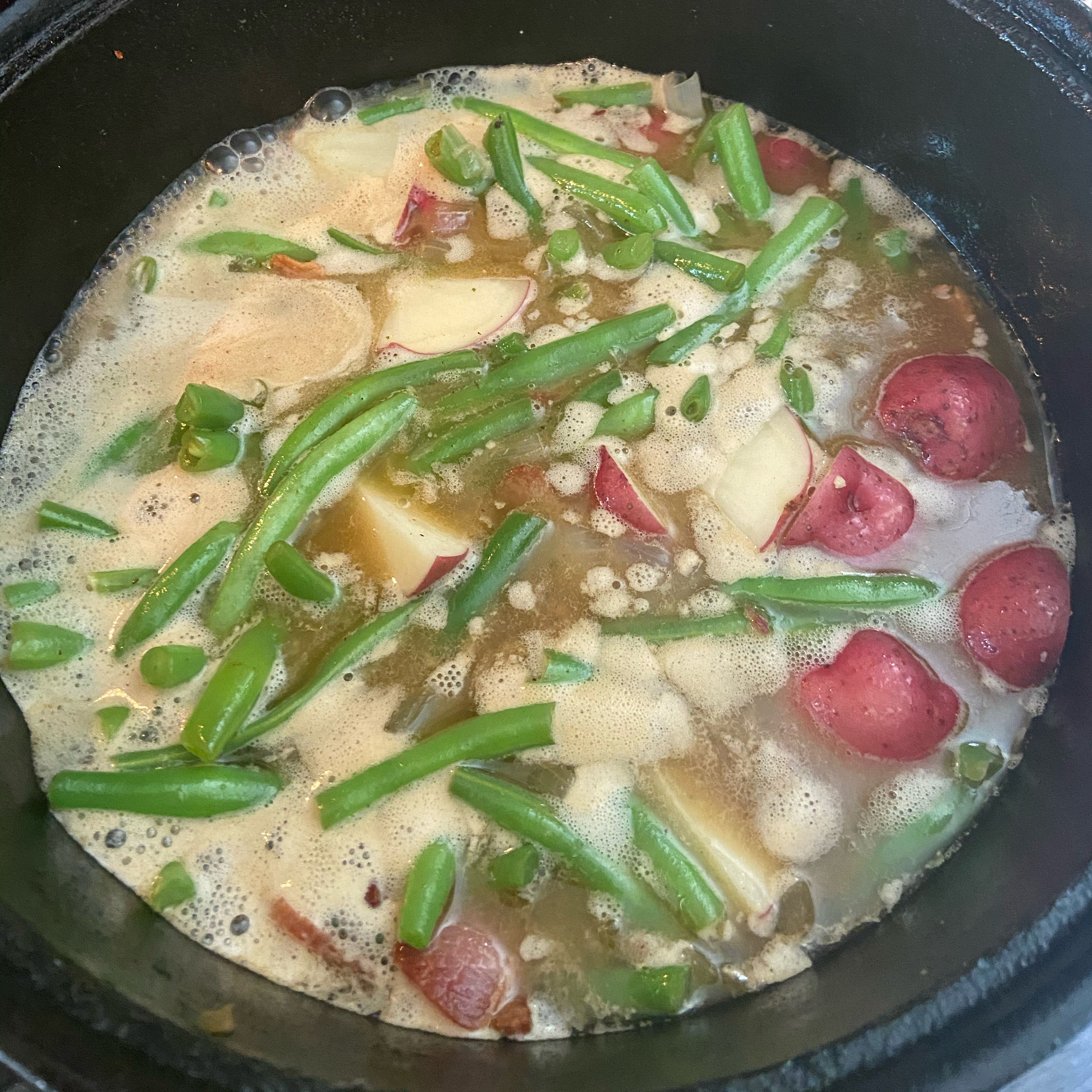Add the Red potatoes and then add enough chicken broth to cover. Add in the butter and salt and pepper to taste. Remember bacon can be salty so you might want to give the broth a quick taste and then add your salt accordingly.￼