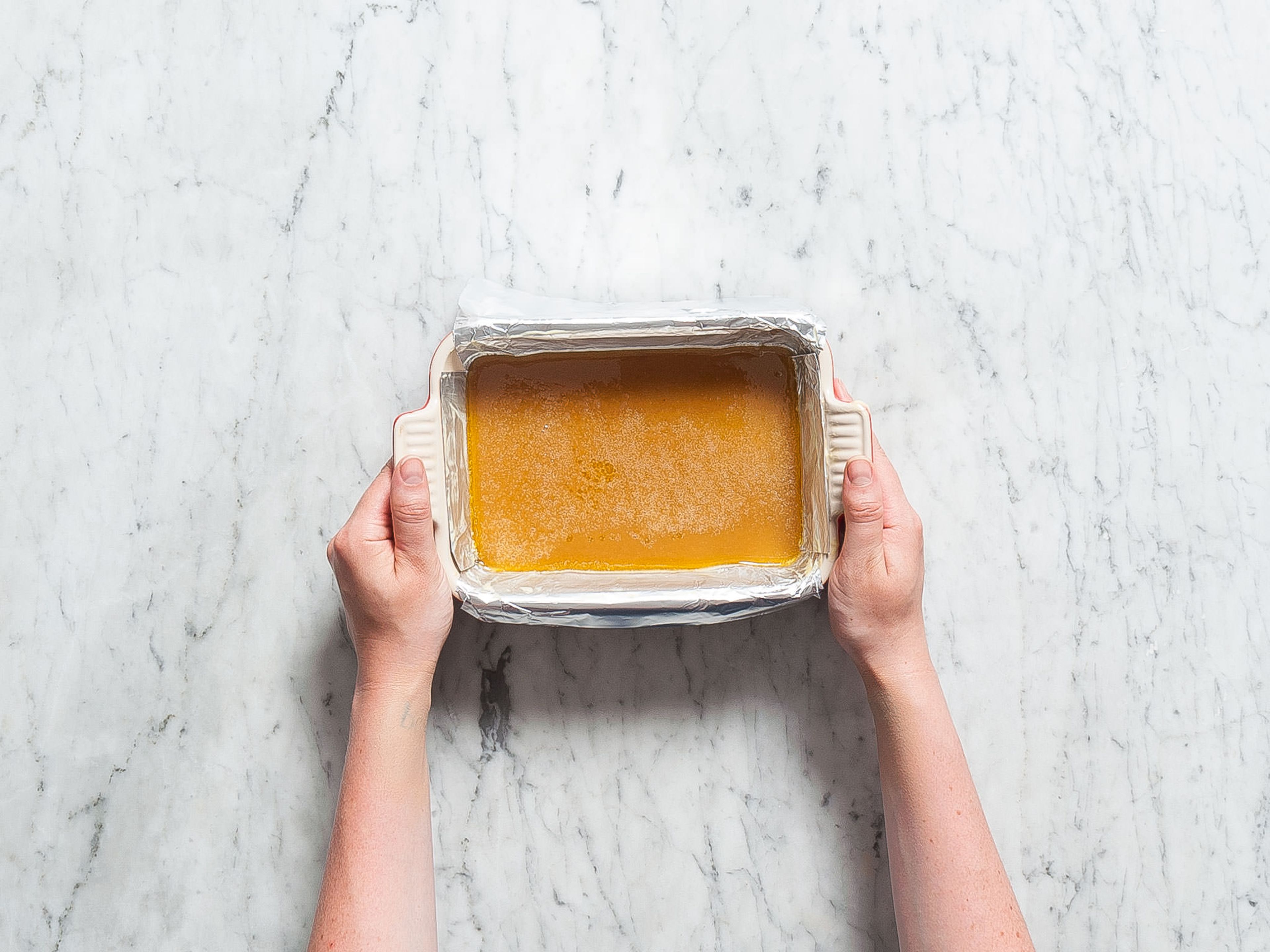 Grease baking dish lined with aluminum foil. Pour caramel mixture into baking dish and refrigerate for approx. 60 min., or until firm. Remove from baking dish and cut into equal-sized candies. Enjoy!