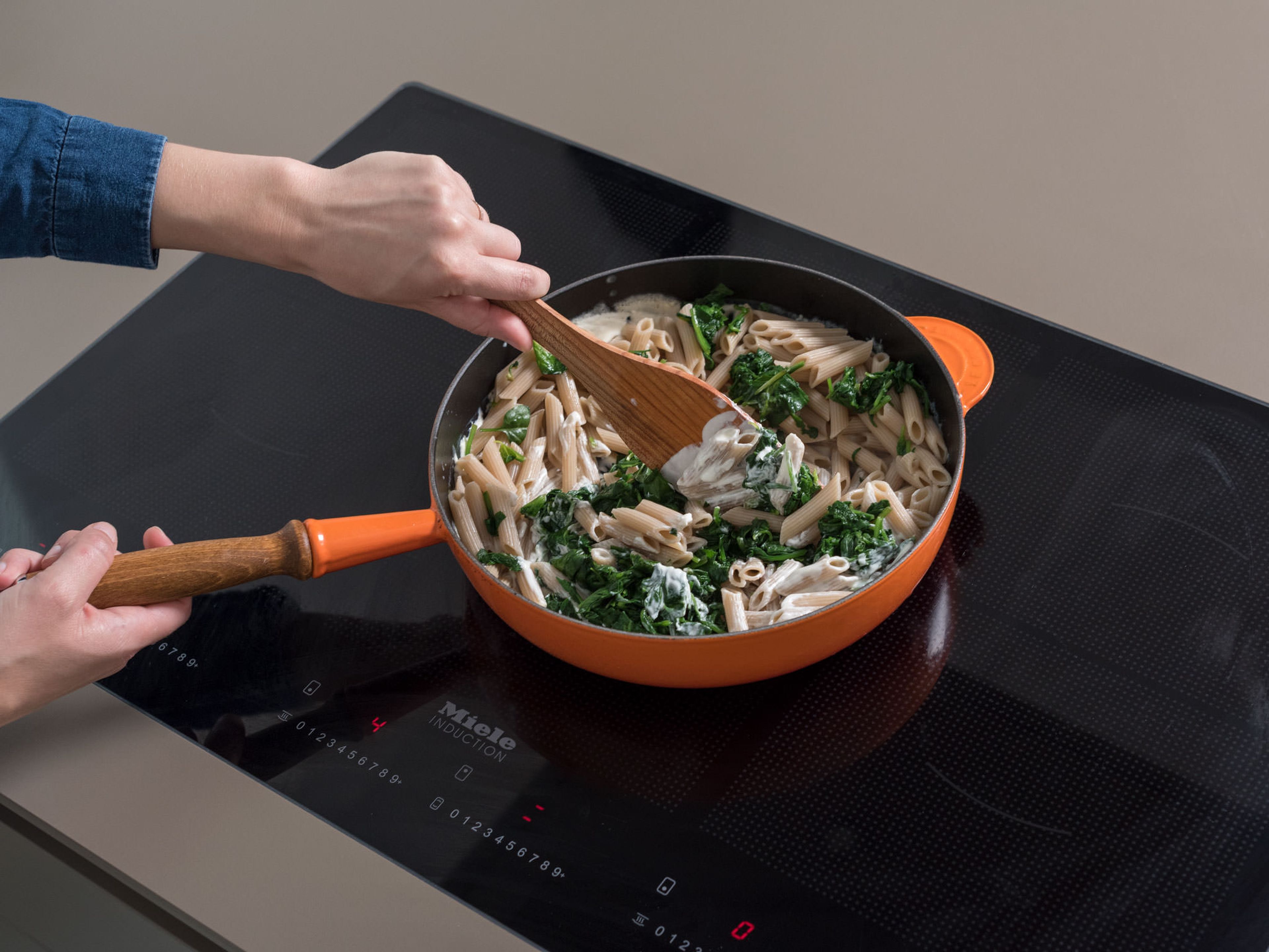 Add spinach and penne to the frying pan and stir. Add a few tablespoons of the reserved pasta water for desired consistency. Season with salt and pepper and serve with toasted pine nuts, more crumbled goat cheese, and Parmesan. Enjoy!