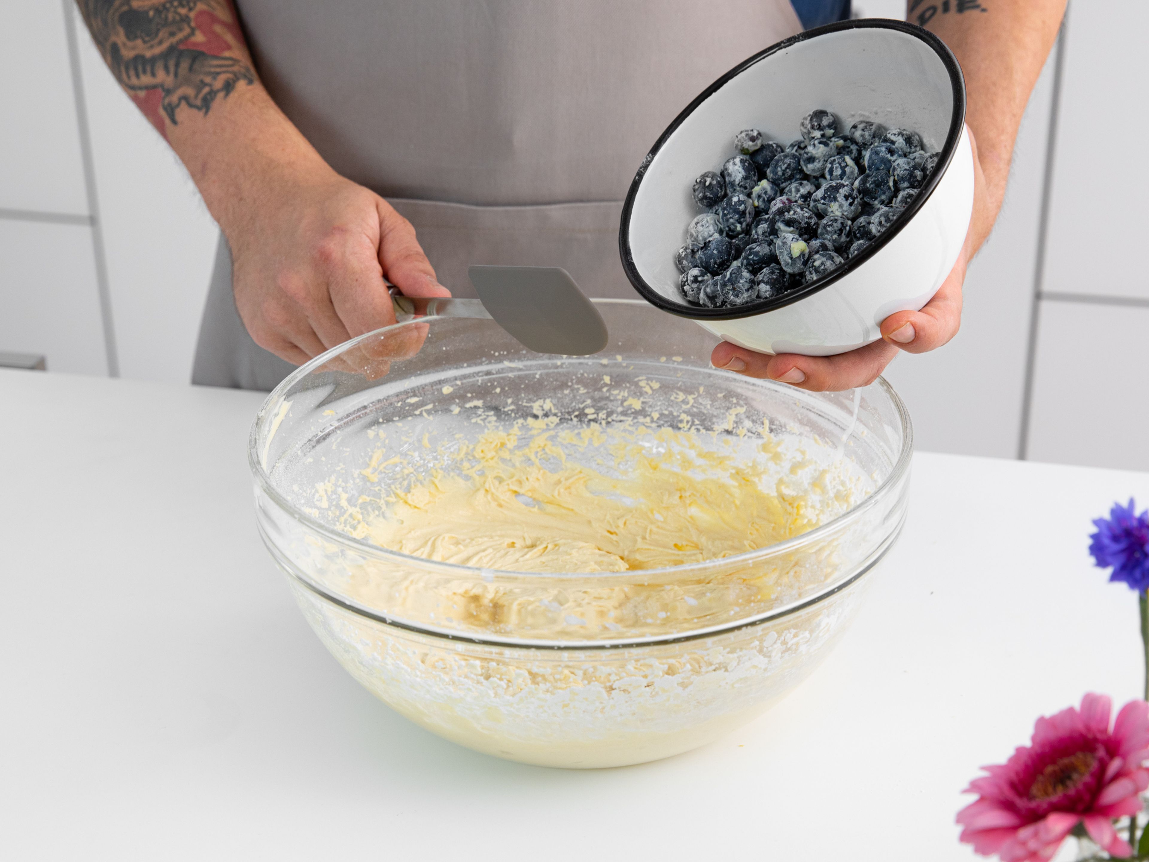 Add half the flour mixture to the butter-sugar mixture. Mix until just combined. While mixing, slowly stream in buttermilk. Add remaining flour and mix, then fold in the blueberries with a rubber spatula.