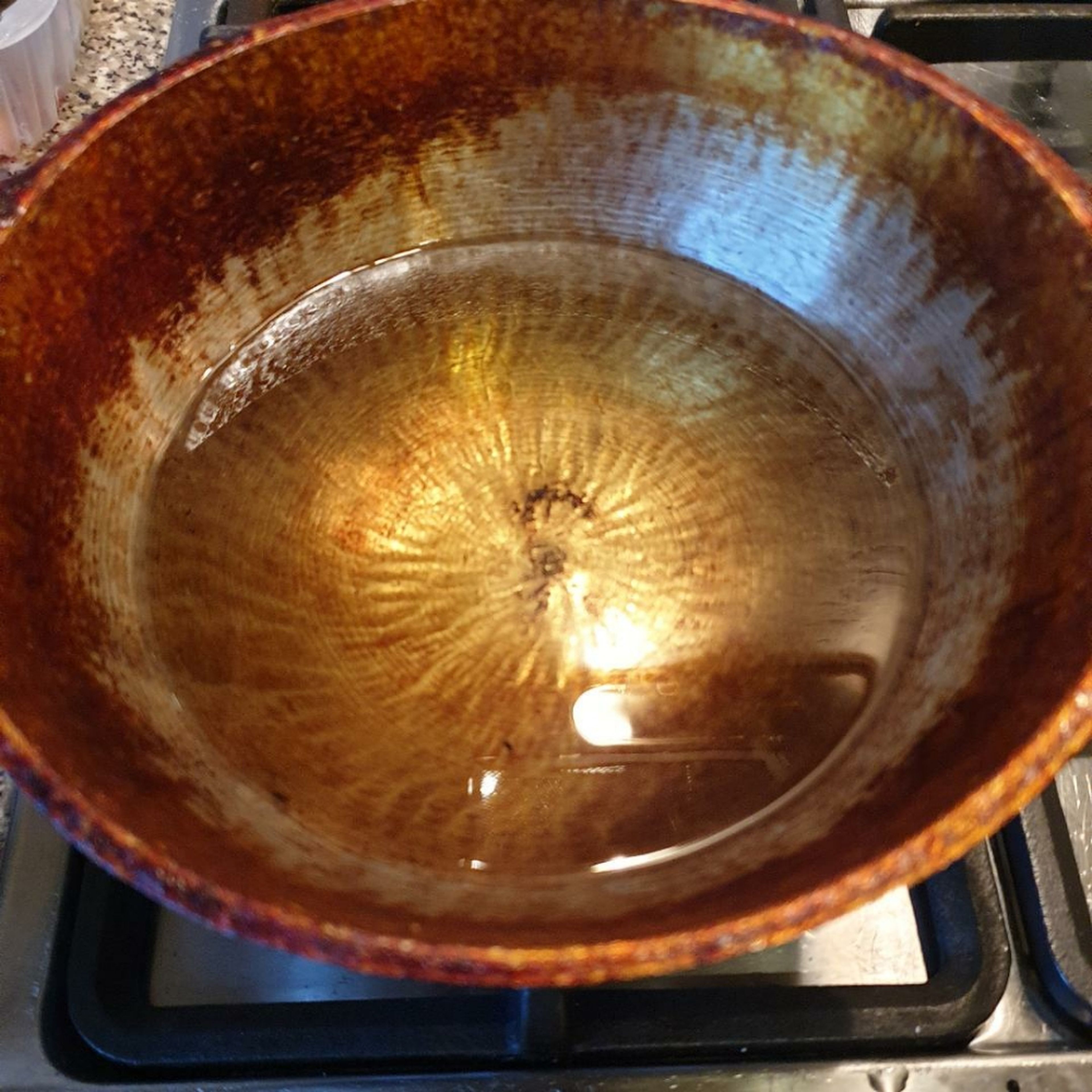 Heat oil in a deep pan.