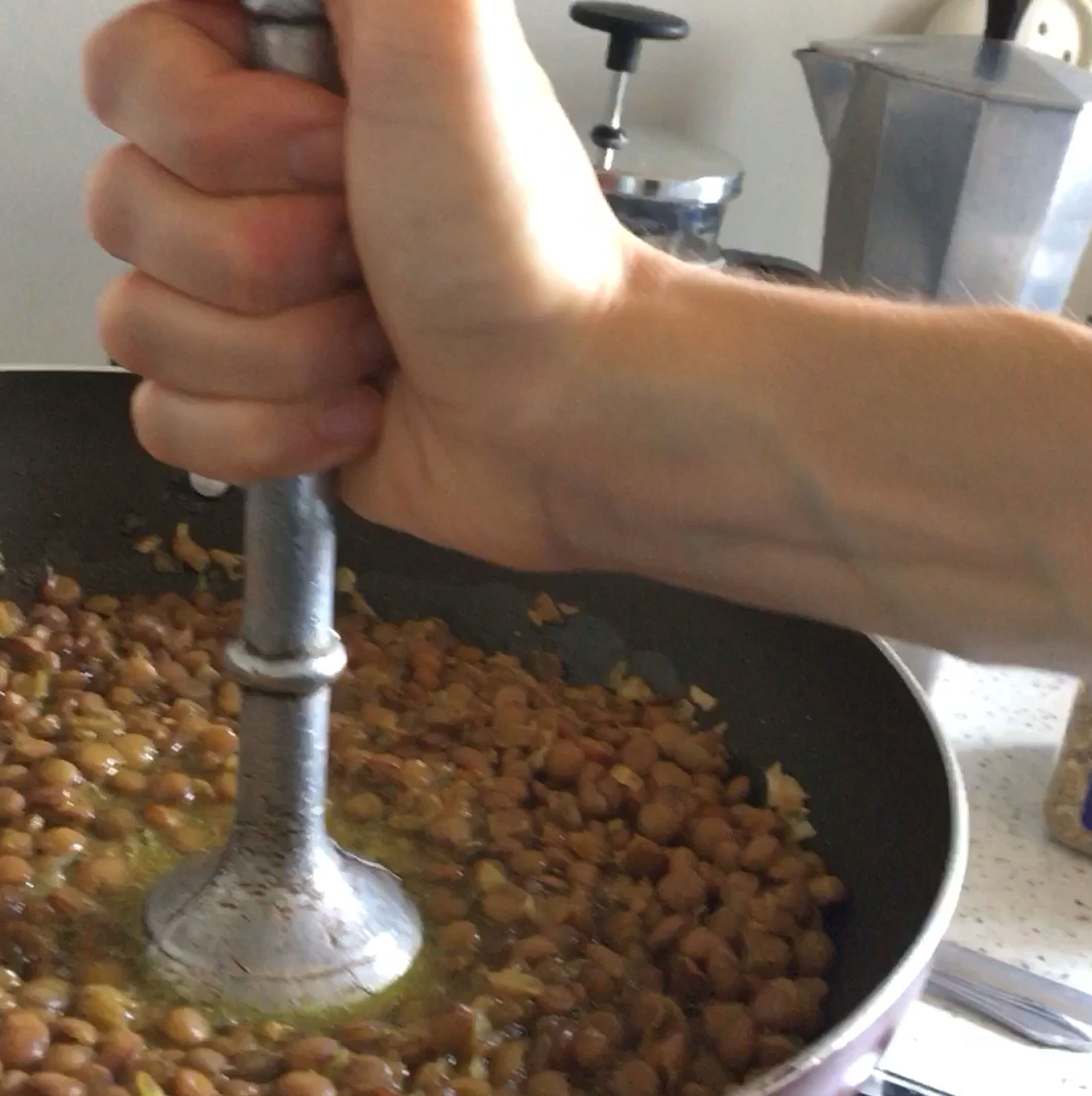When lentils are cooked, generously season them with salt then add in the onion mixture and stir well. Mash part of the whole thing with whatever you have on hand…
