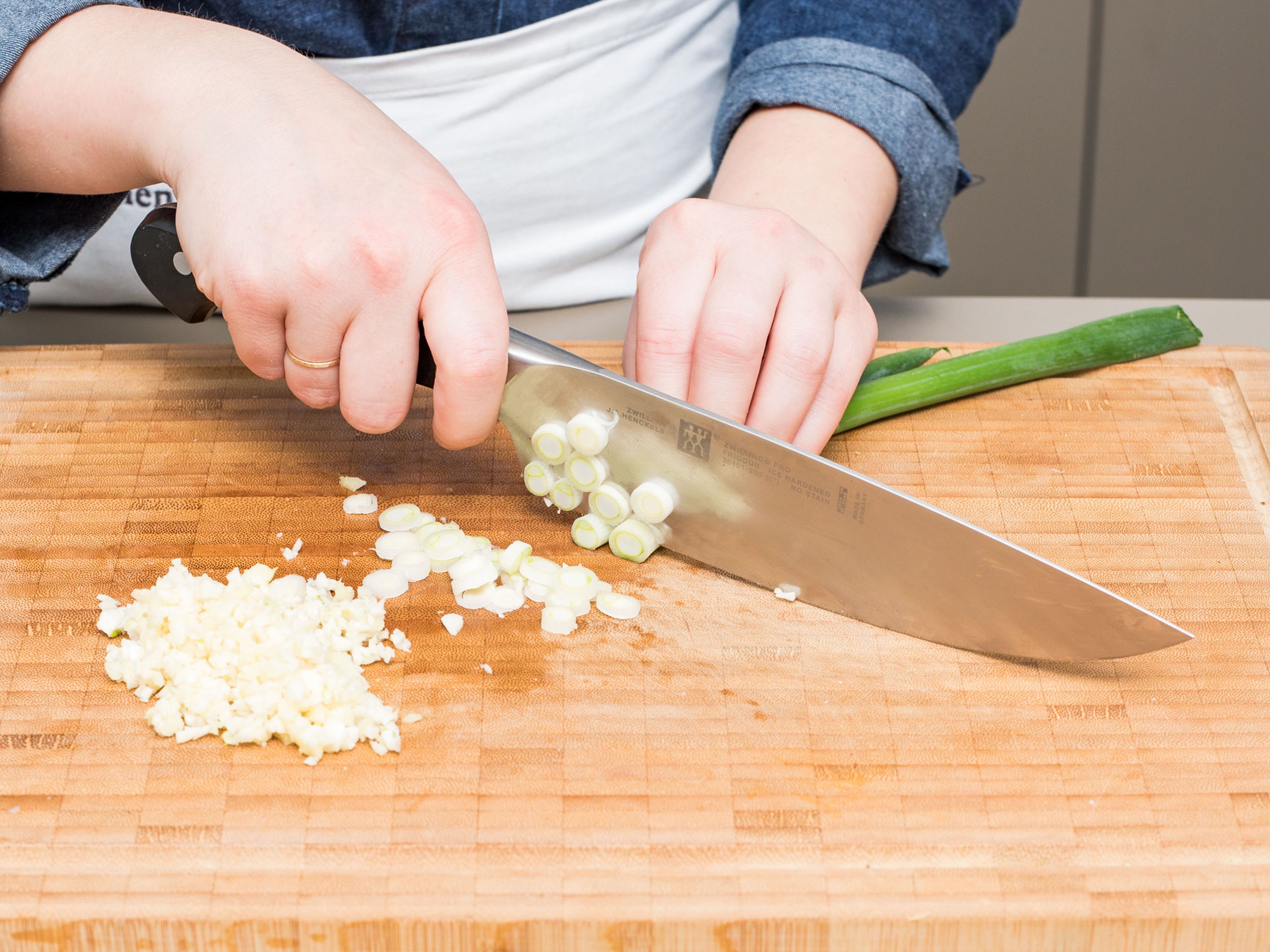 Peel and finely chop some garlic and ginger. Cut the white part of scallions in rings, save the green part for later.