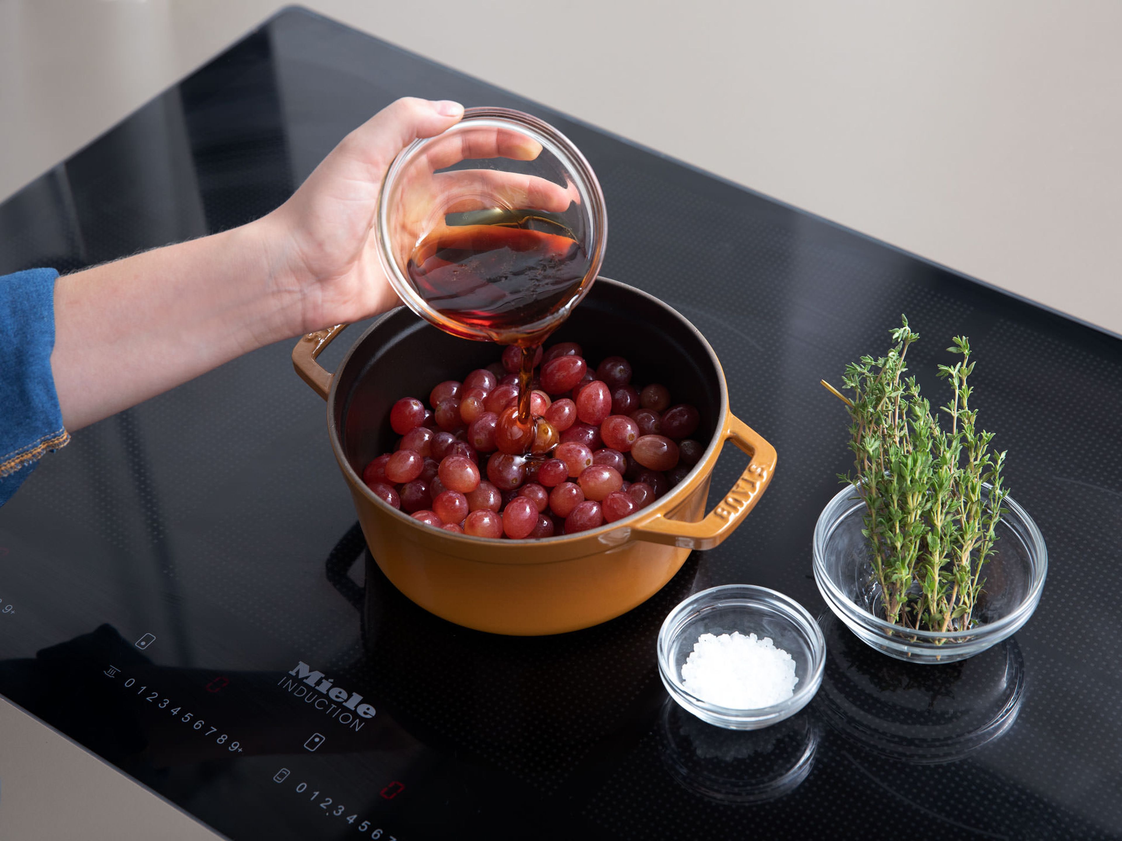 Wash grapes and add to a pot set over medium-high heat along with the maple syrup, thyme, and a pinch of sea salt. Bring to a boil and let simmer on low heat for approx. 10 min., or until grapes are soft and have burst. Set aside and let cool.