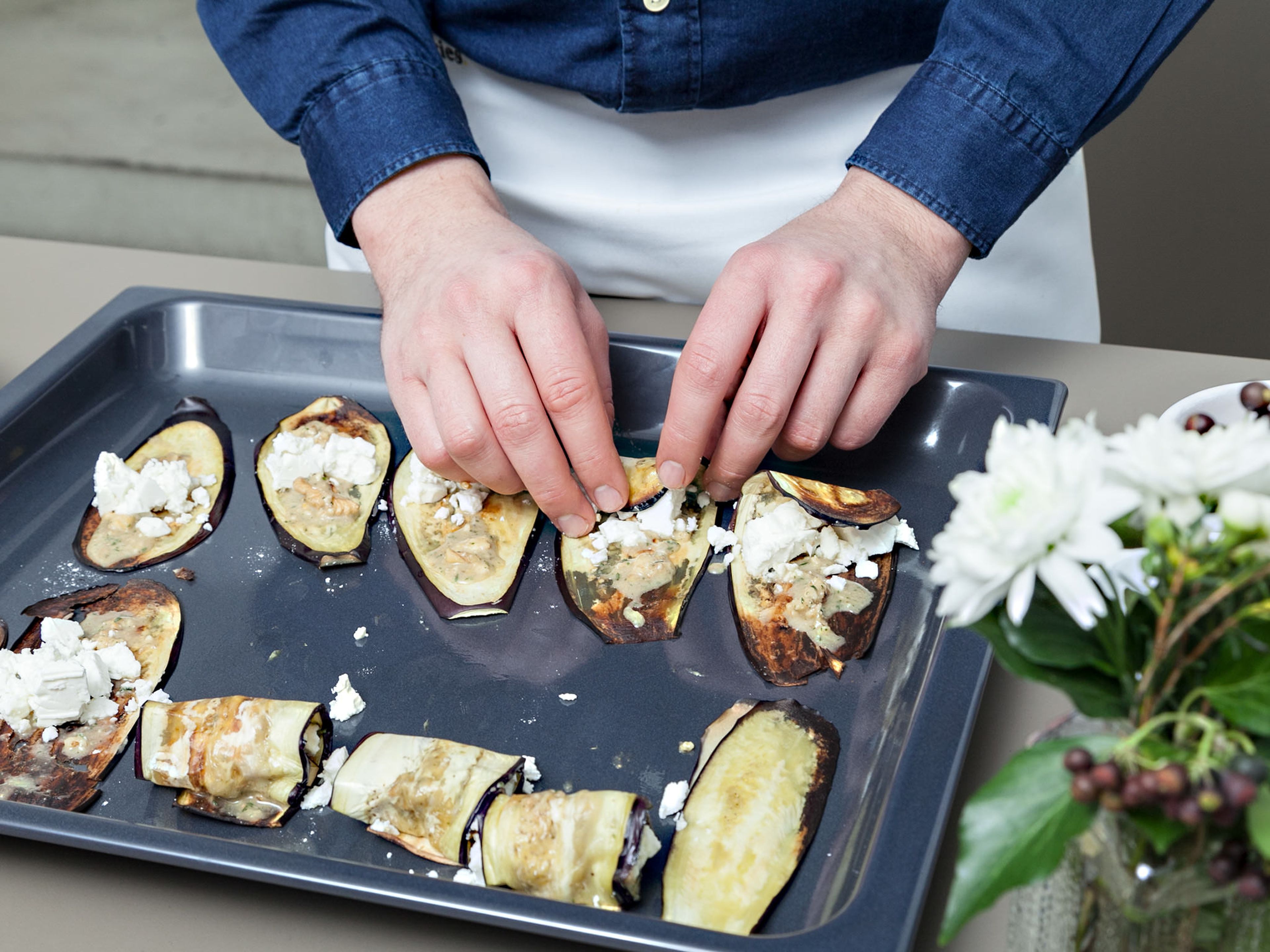 Coat cooked eggplant slices with walnut-thyme paste and place a small spoonful of goat cheese in the center of each slice. Roll up the slices.