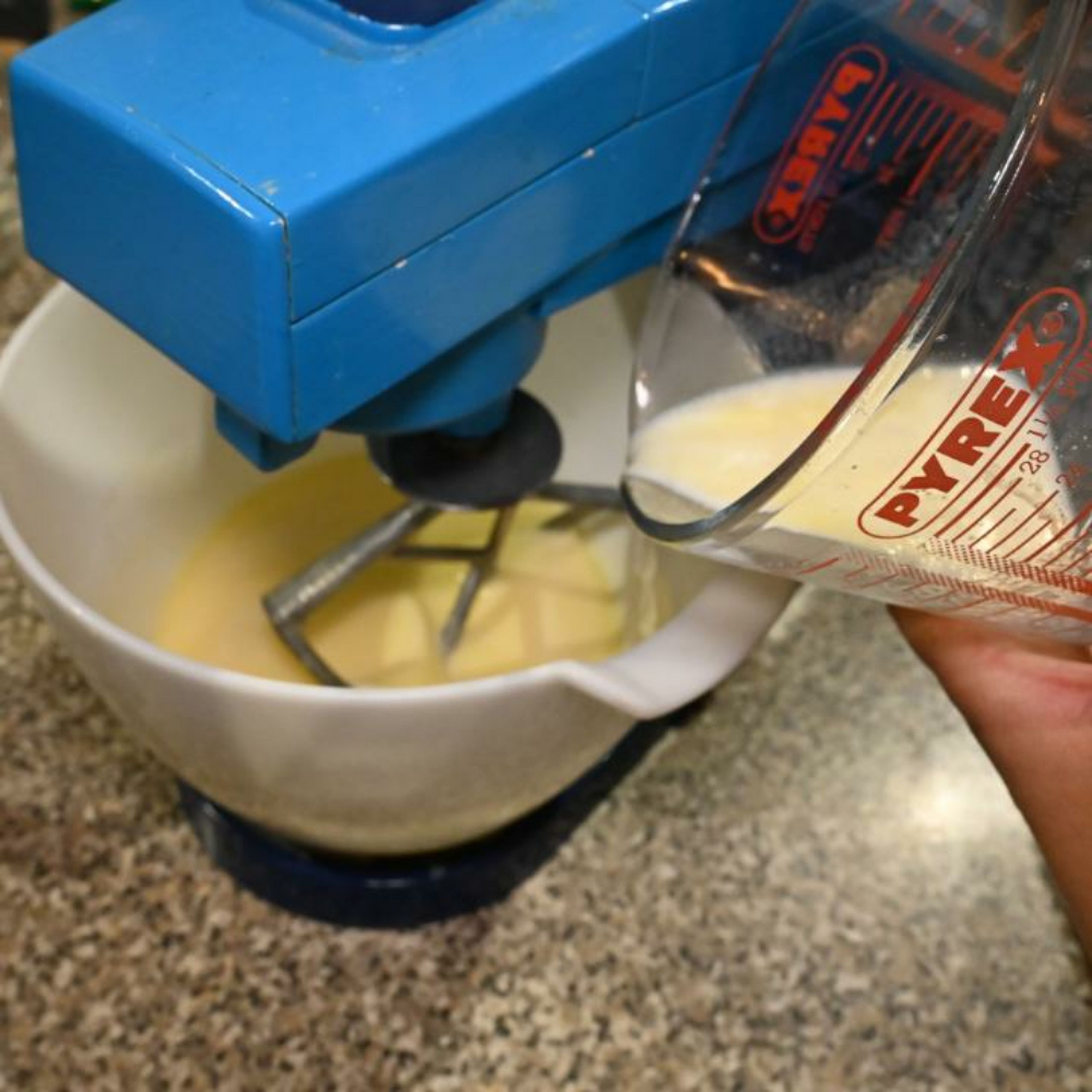 Add the prepared buttermilk to the egg mixture and continue whisking at low speed.
