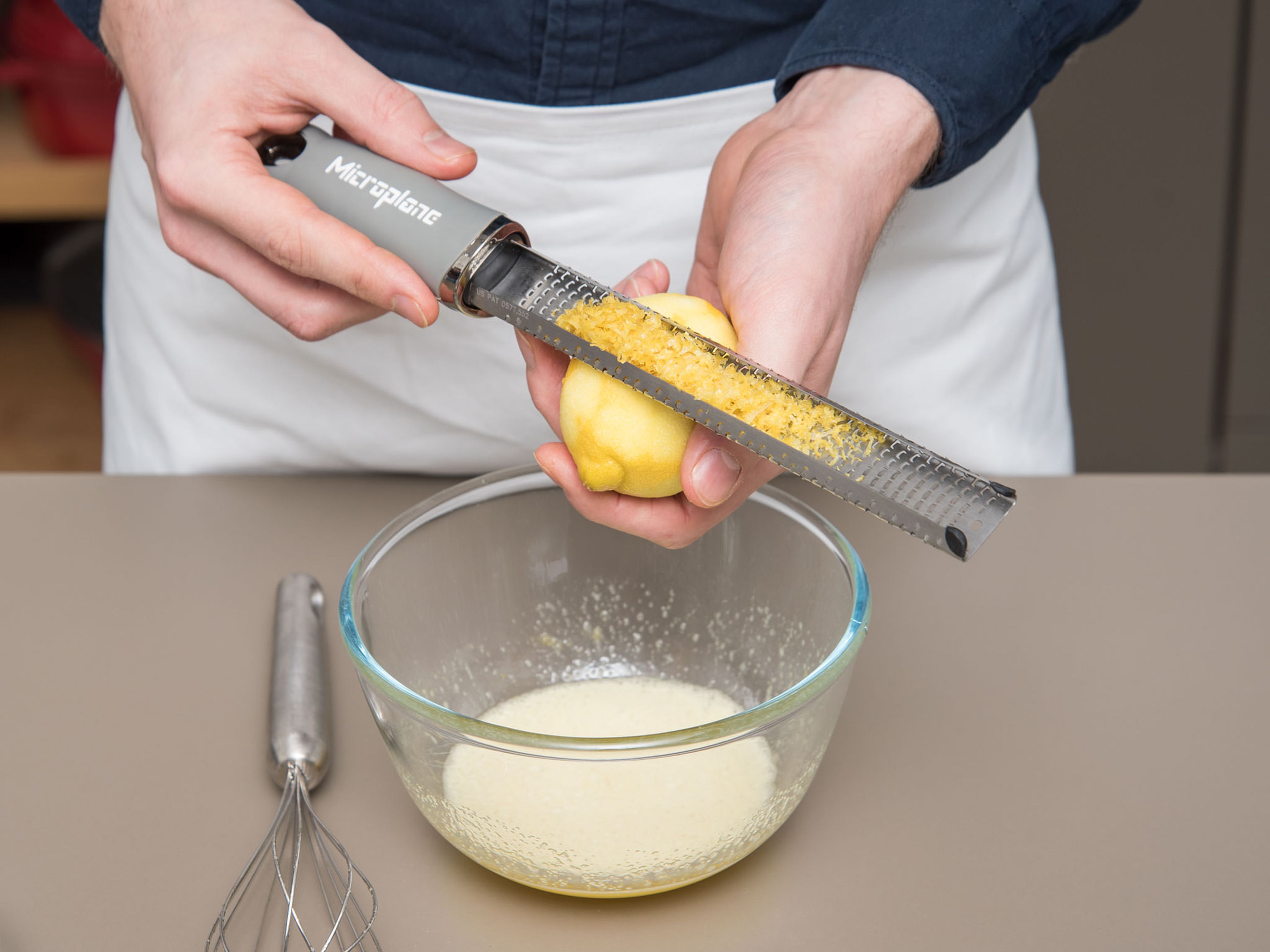 Add egg and sugar to a bowl and whisk until combined. Stir in honey and add lemon zest. Stir to combine until a smooth batter forms.