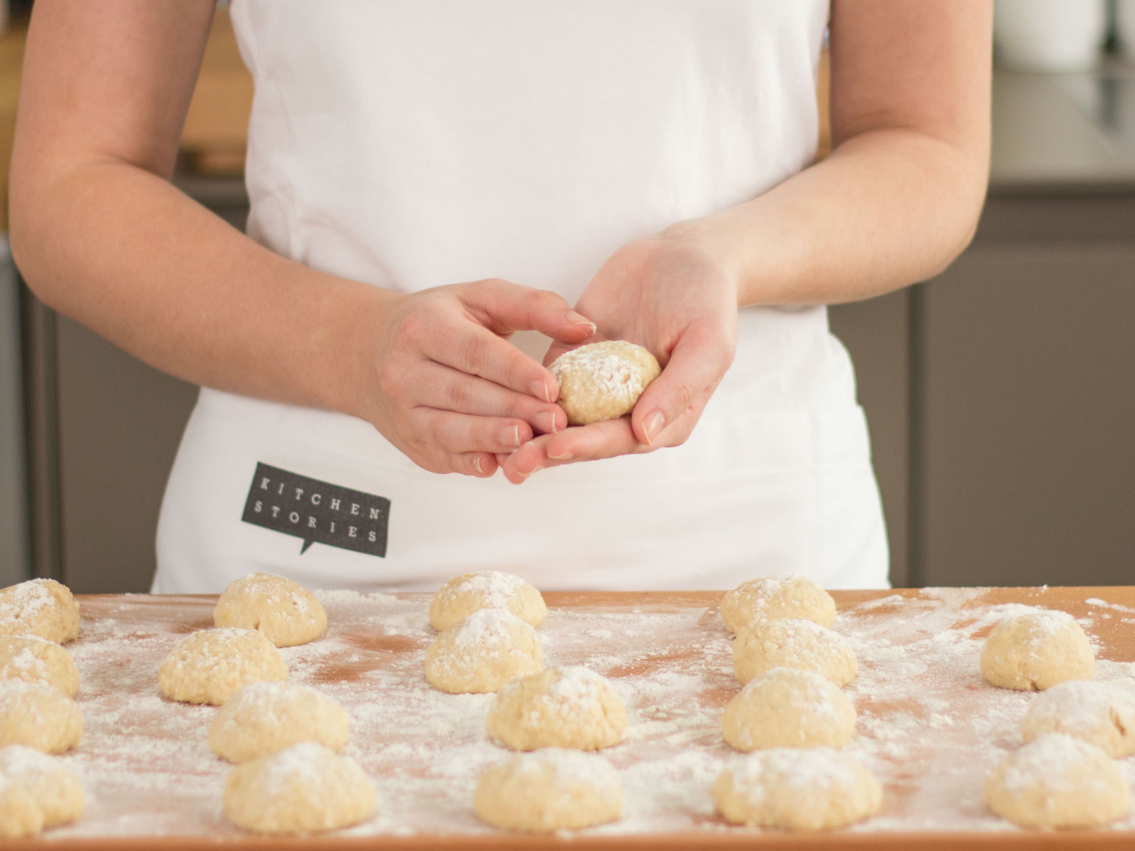 Transfer dough to a floured work surface. Now, form the dough into small, golf ball-sized rounds. Allow to rise for approx. 25 – 30 min. Then, flatten out dough and with a small cookie cutter, cut out the center of the dough. Allow dough to rise for approx. another 50 – 60 min.