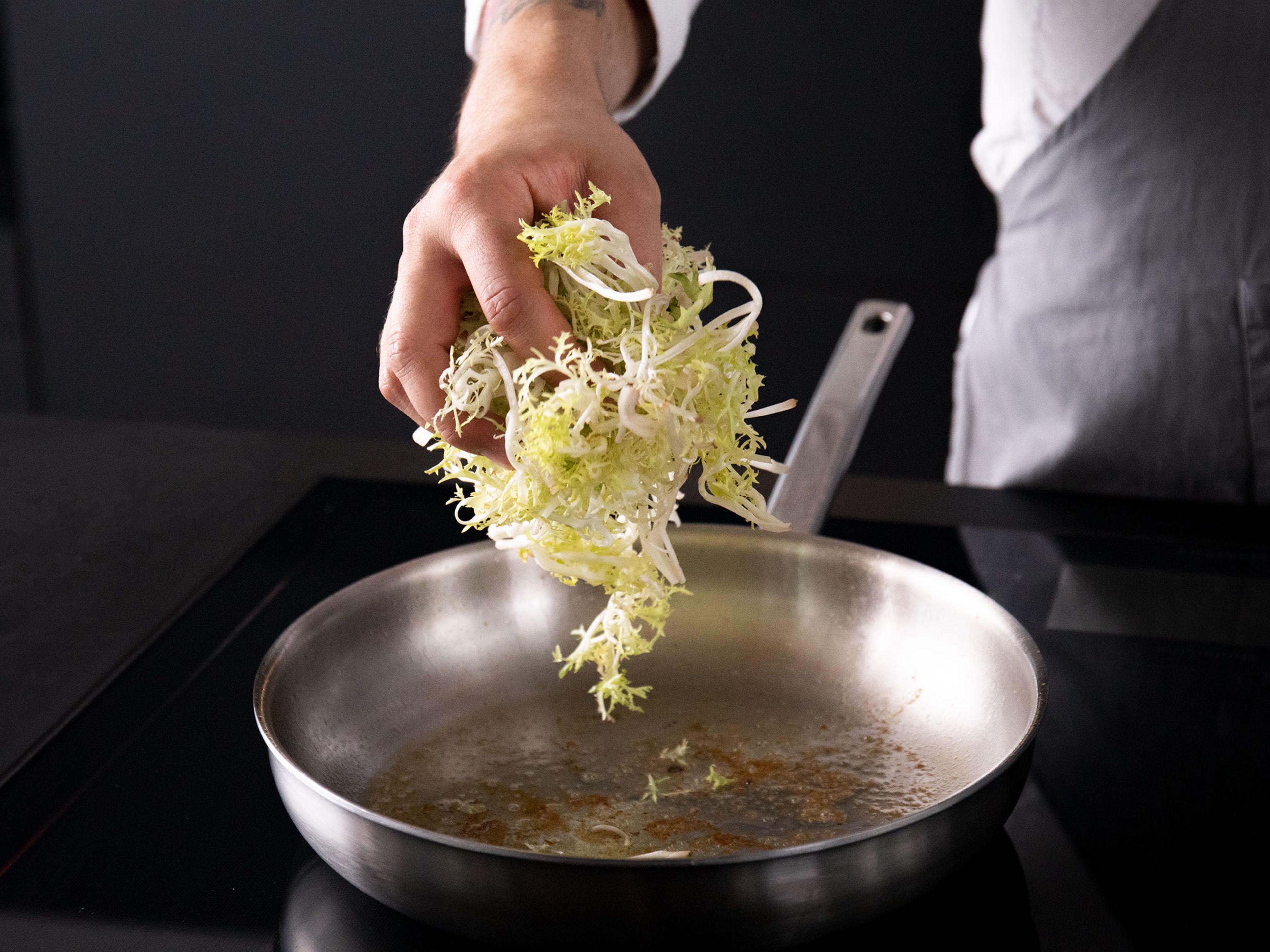 Remove chicken from pan and set aside. Add frisée to the pan over low heat with the chicken fat, toss, and let sit for approx. 5 min., or until lightly wilted.