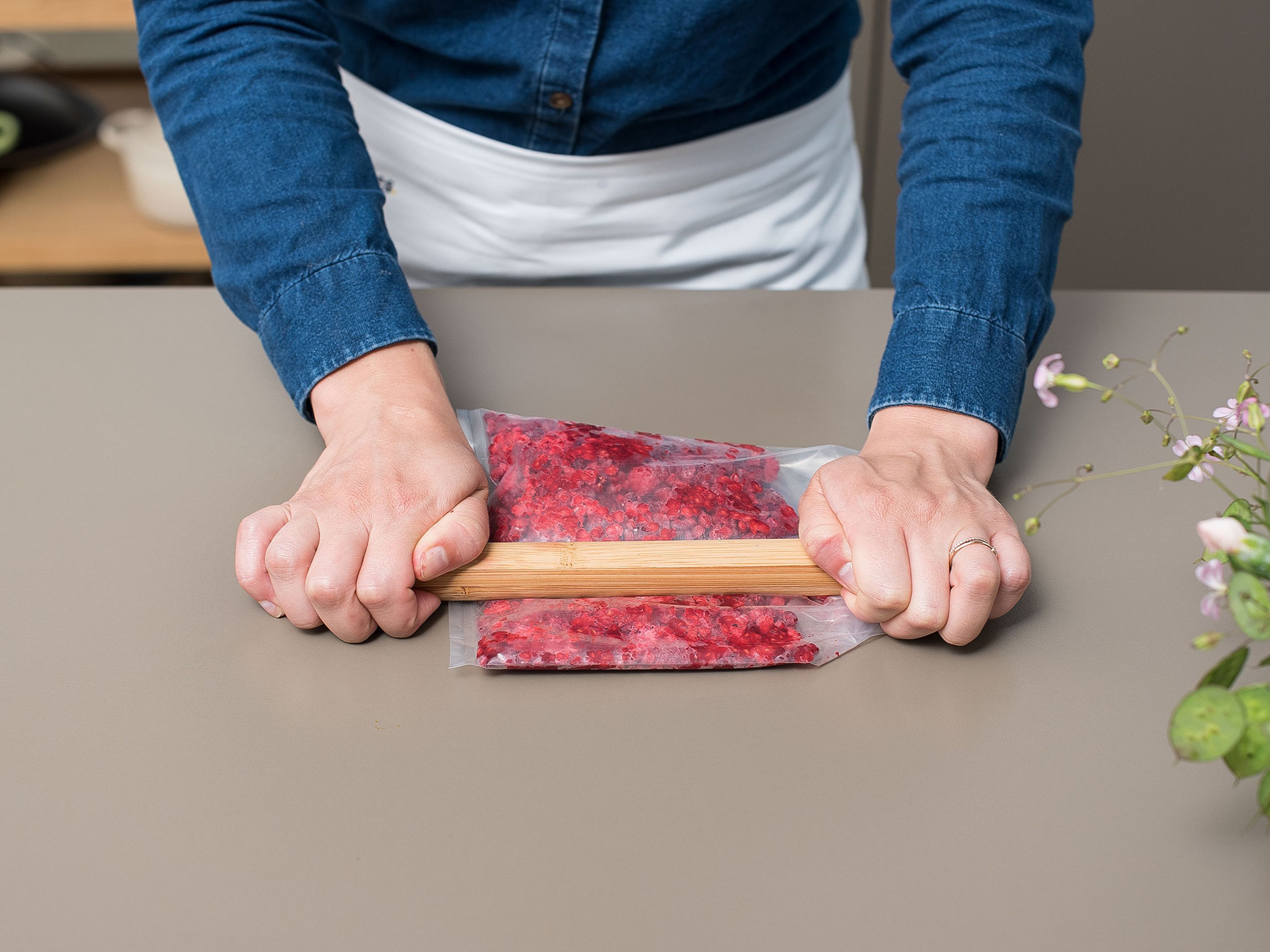 Use a rolling pin to mash up raspberries in a sealable plastic bag and add to popsicle molds, approx. 1 tbsp. per mold.