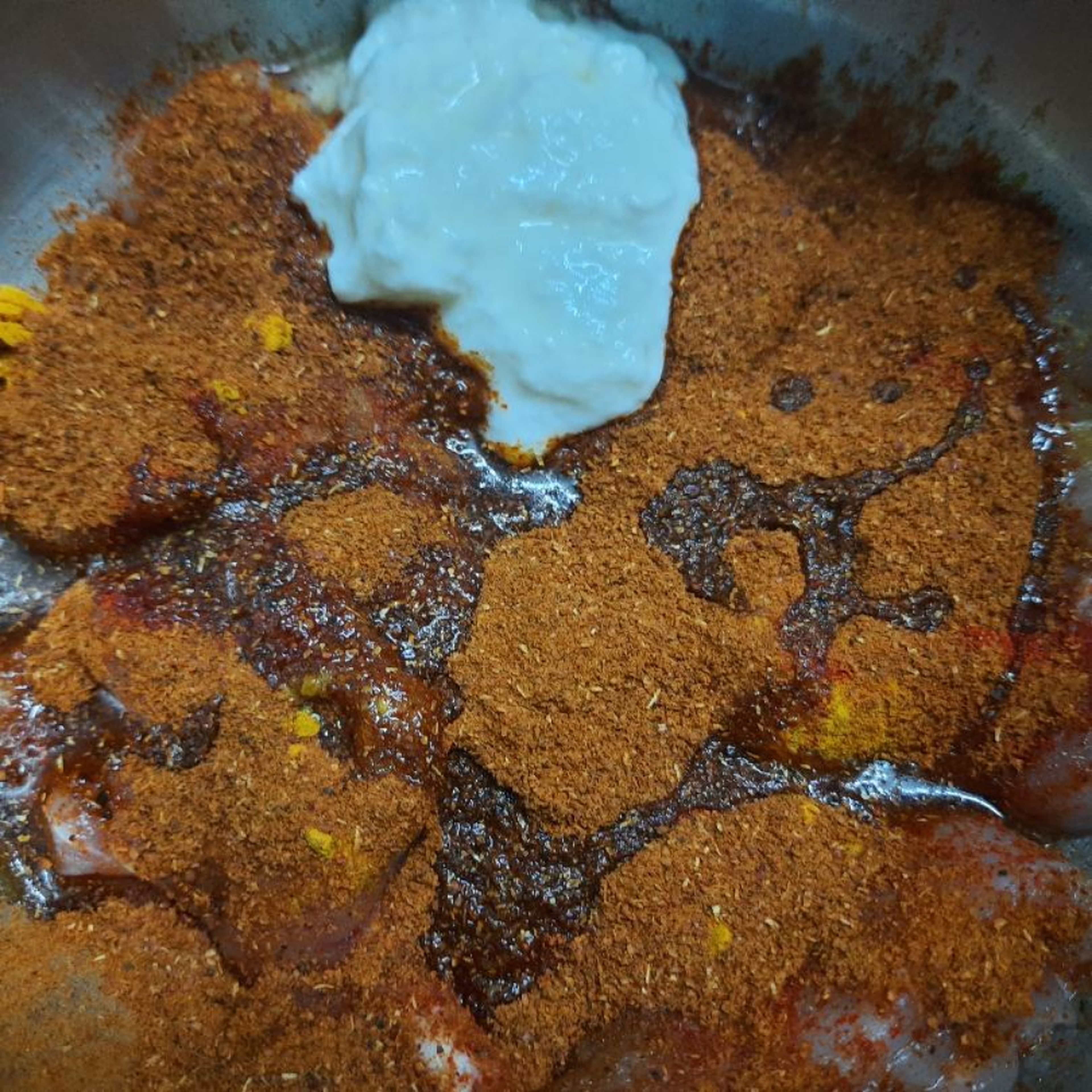 Put the pieces in a bowl. Add salt, turmeric powder, chilli powder, chicken masala (or meat masala or garam masala) powder, garlic-ginger paste, curd and 1tsp oil.