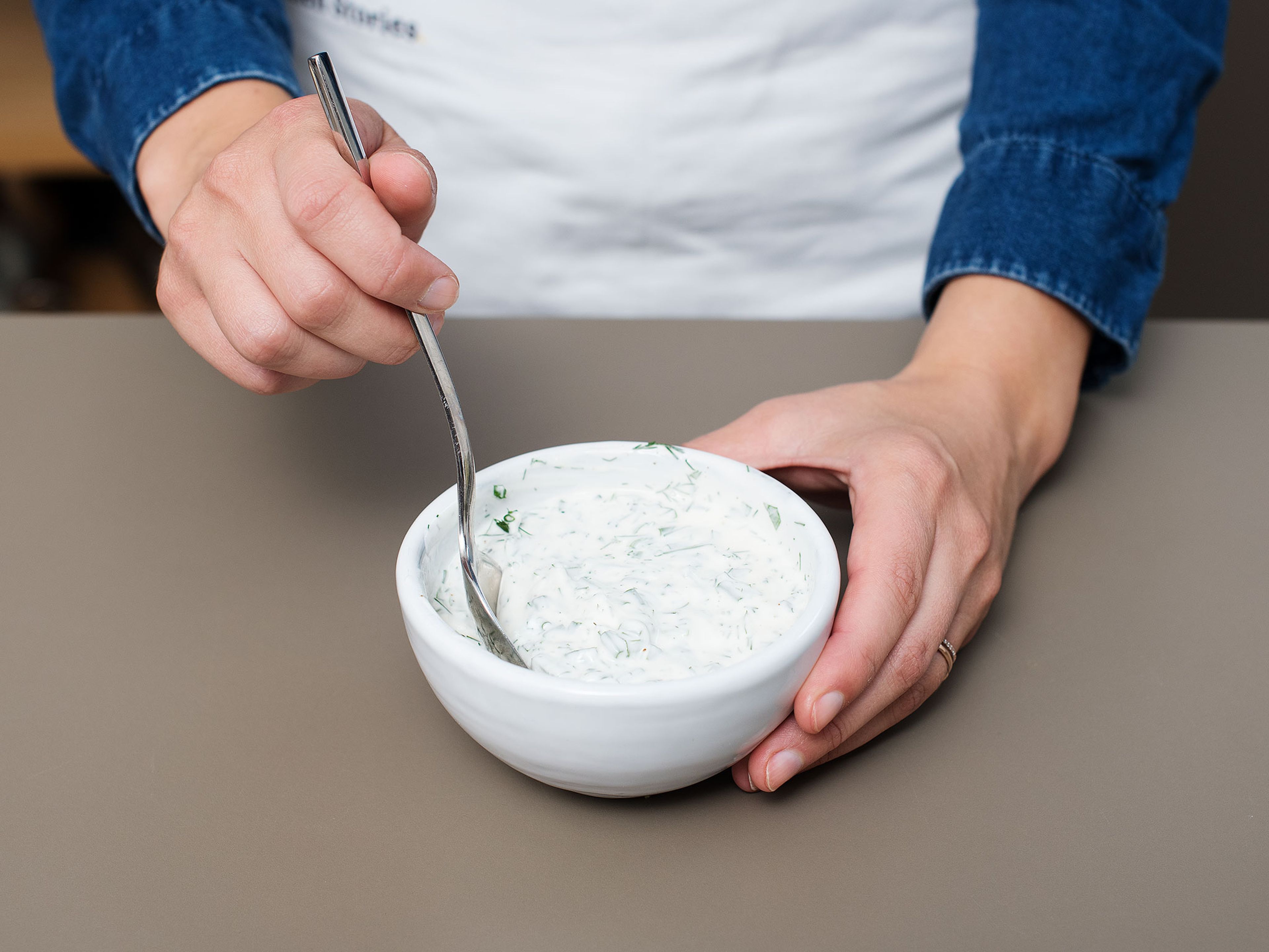 Mix herbs with sour cream. Season with salt and pepper and set aside.