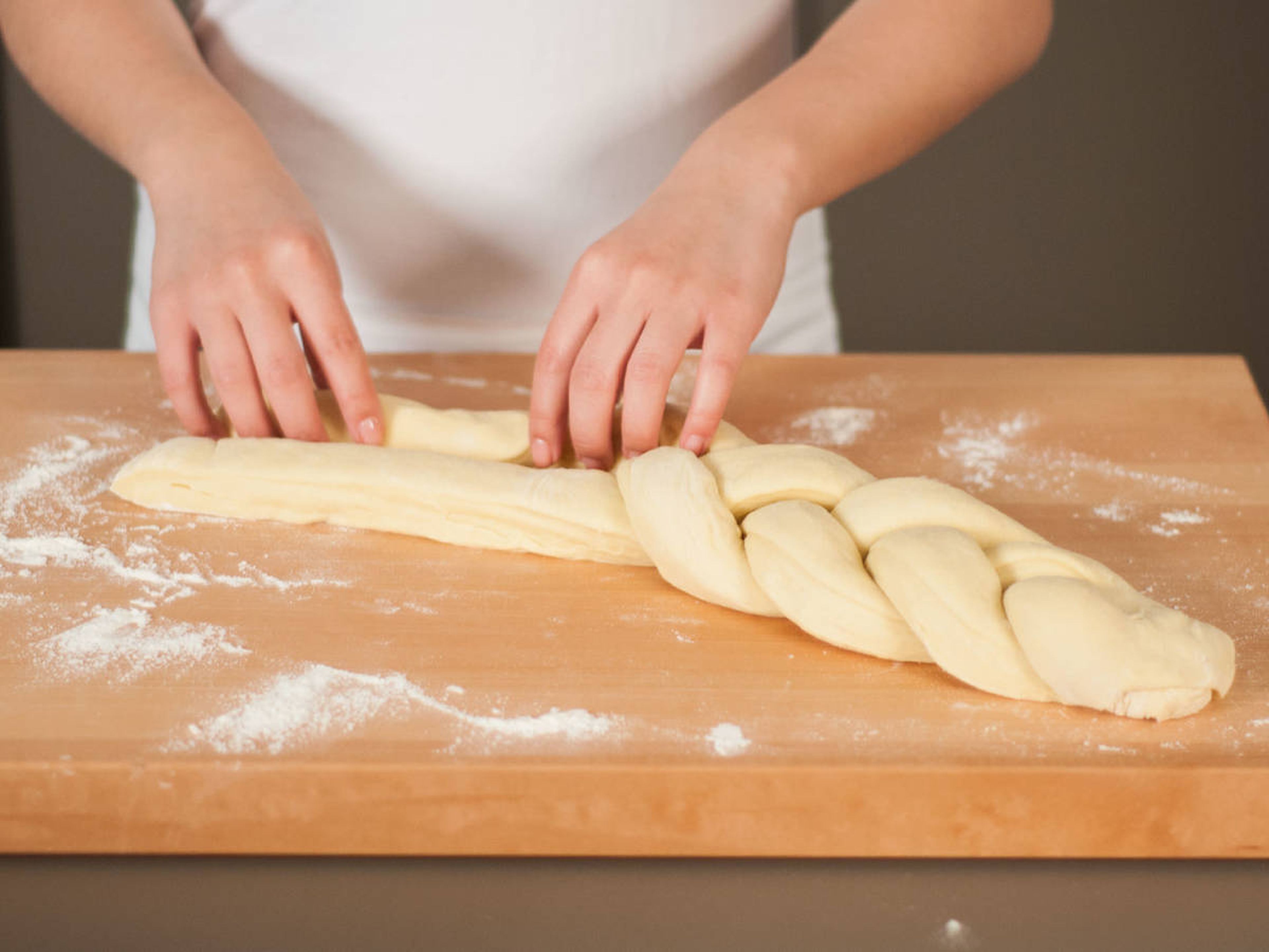 Beginning from the top, carefully braid dough into a loaf. Tightly seal loose ends.