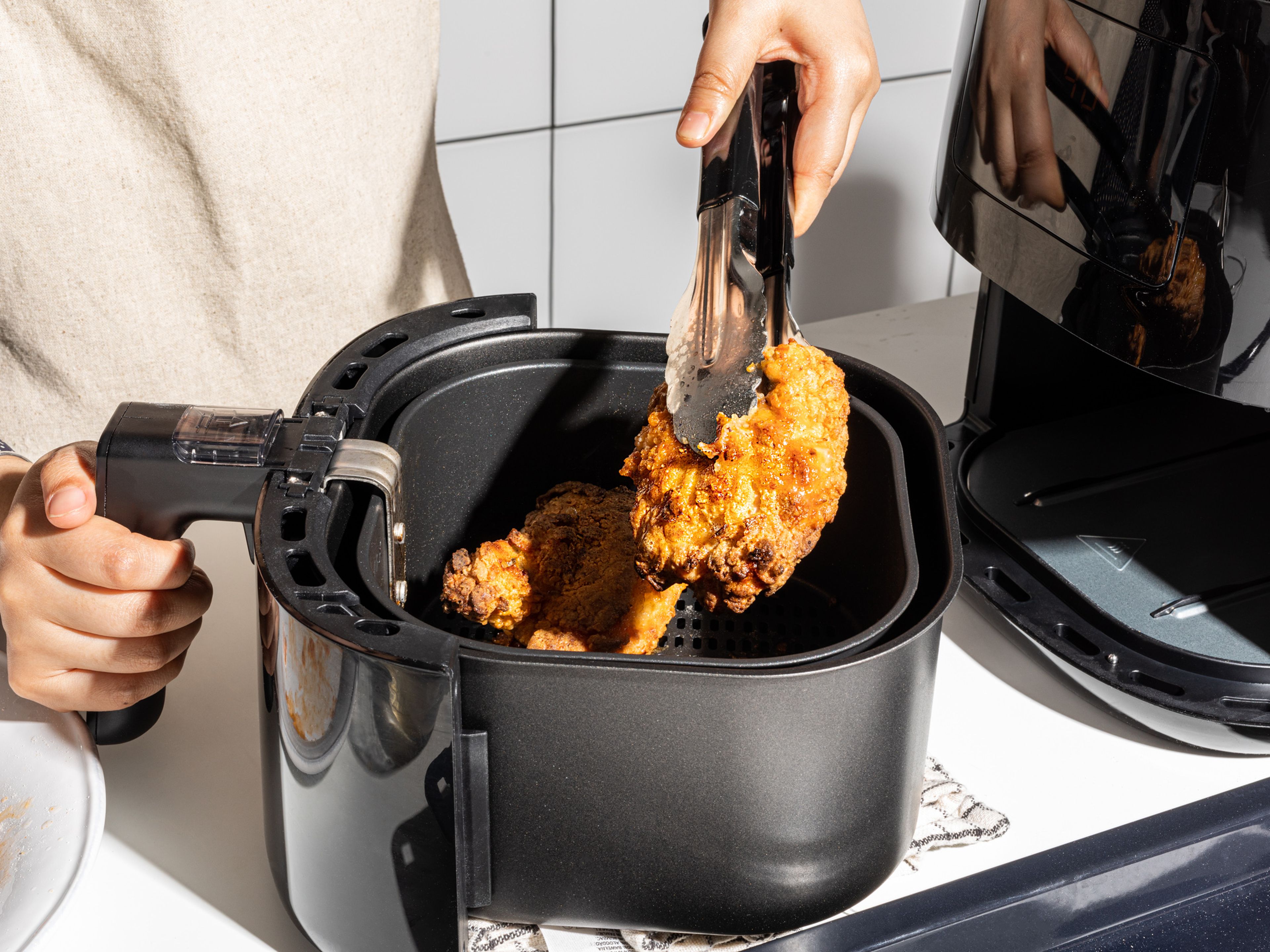 For the air fryer chicken, heat up the air fryer to 200°C/400°F or to your air-fryer’s recommended heat setting for chicken (if it has one). Cook in batches, according to the size of your air fryer, for approx. 20 min. Halfway through the frying time, flip the chicken pieces and brush with more oil. Place cooked pieces onto a rack.