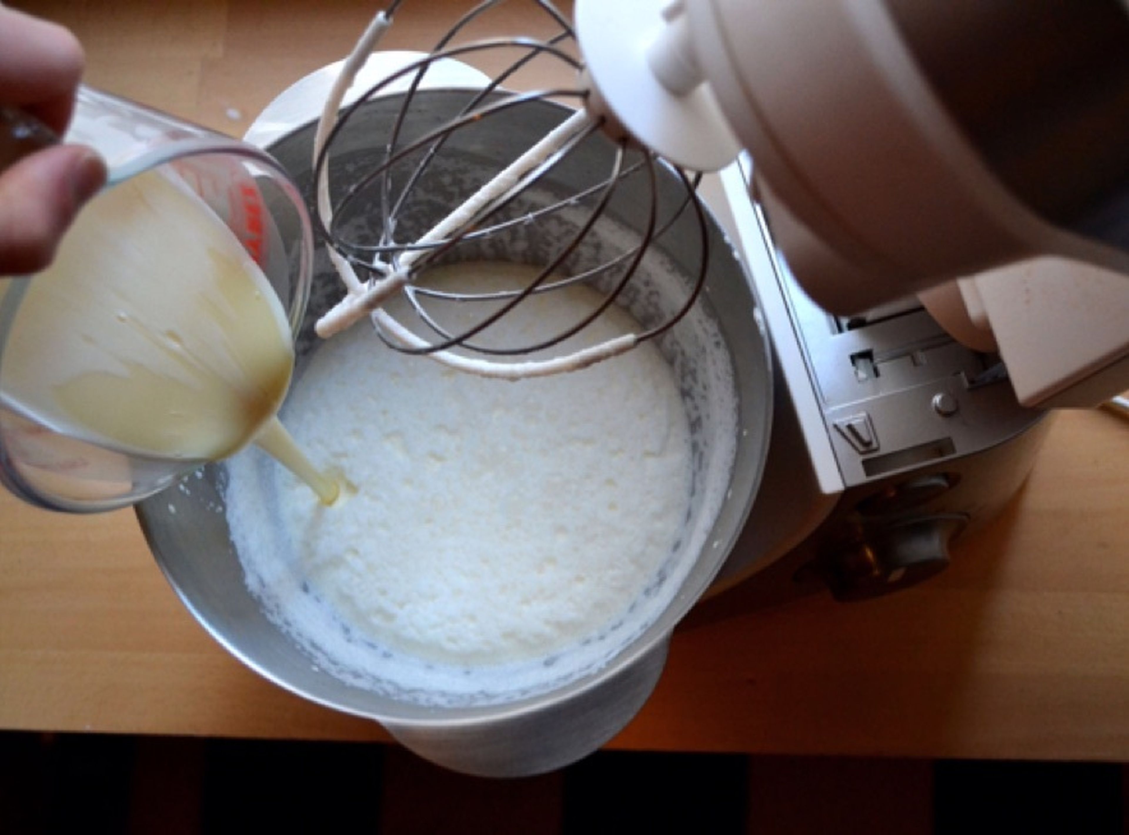 Whisk the double cream until thick but still pourable, then add the condensed milk and whisk until the mixture holds its form.