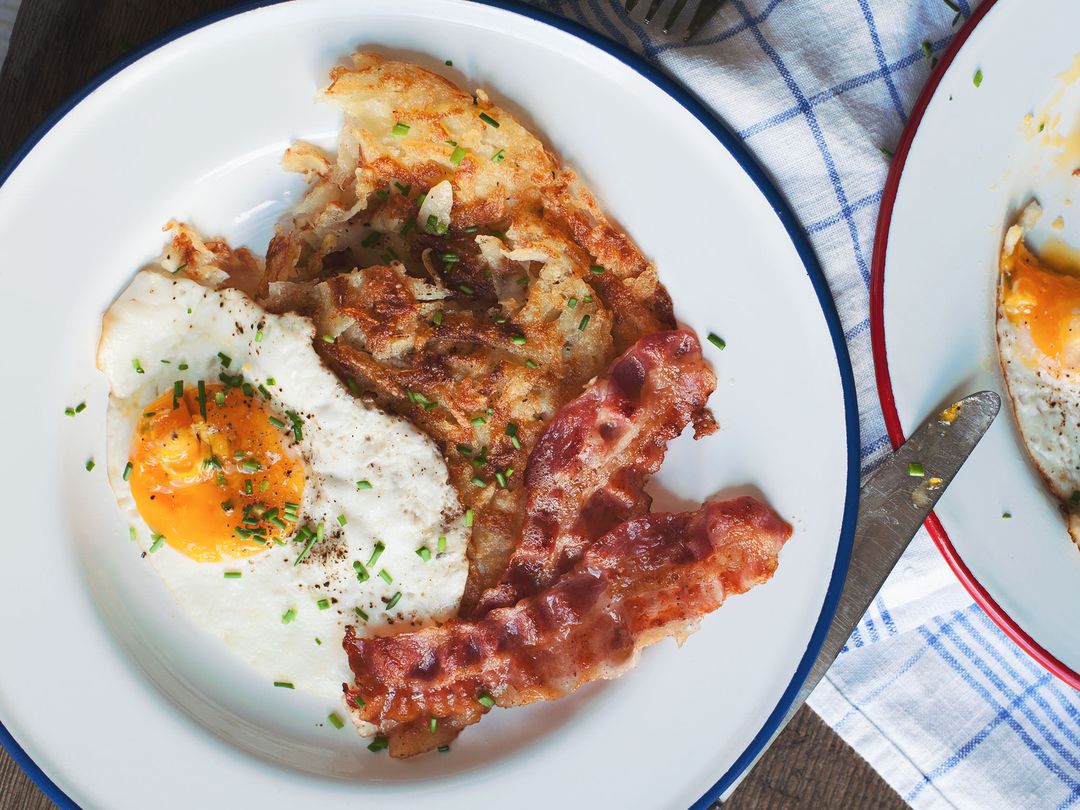 Hash browns with fried eggs and bacon