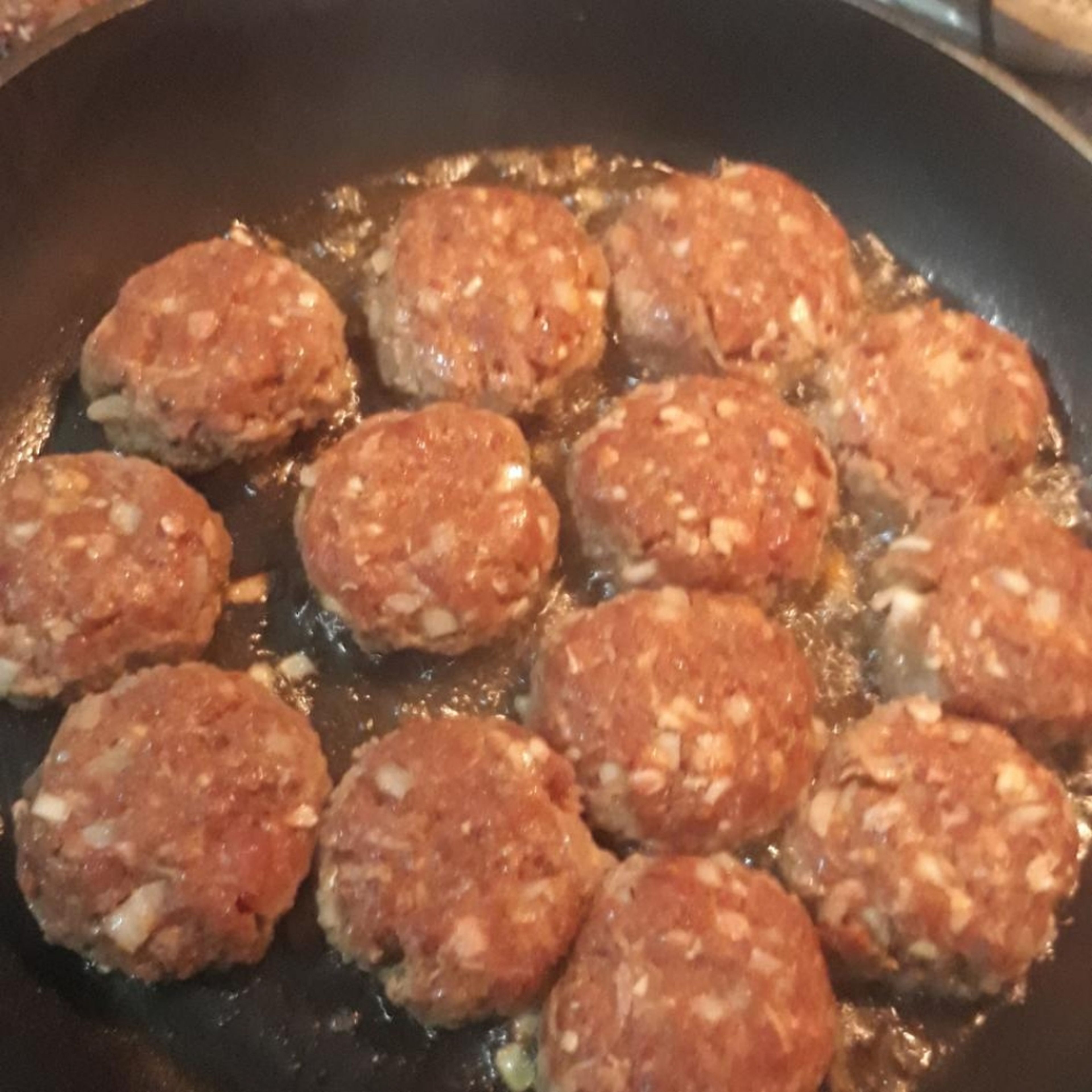 Putt a little oil in your pan and wait when the pan get hot enough put your meatballs in it.