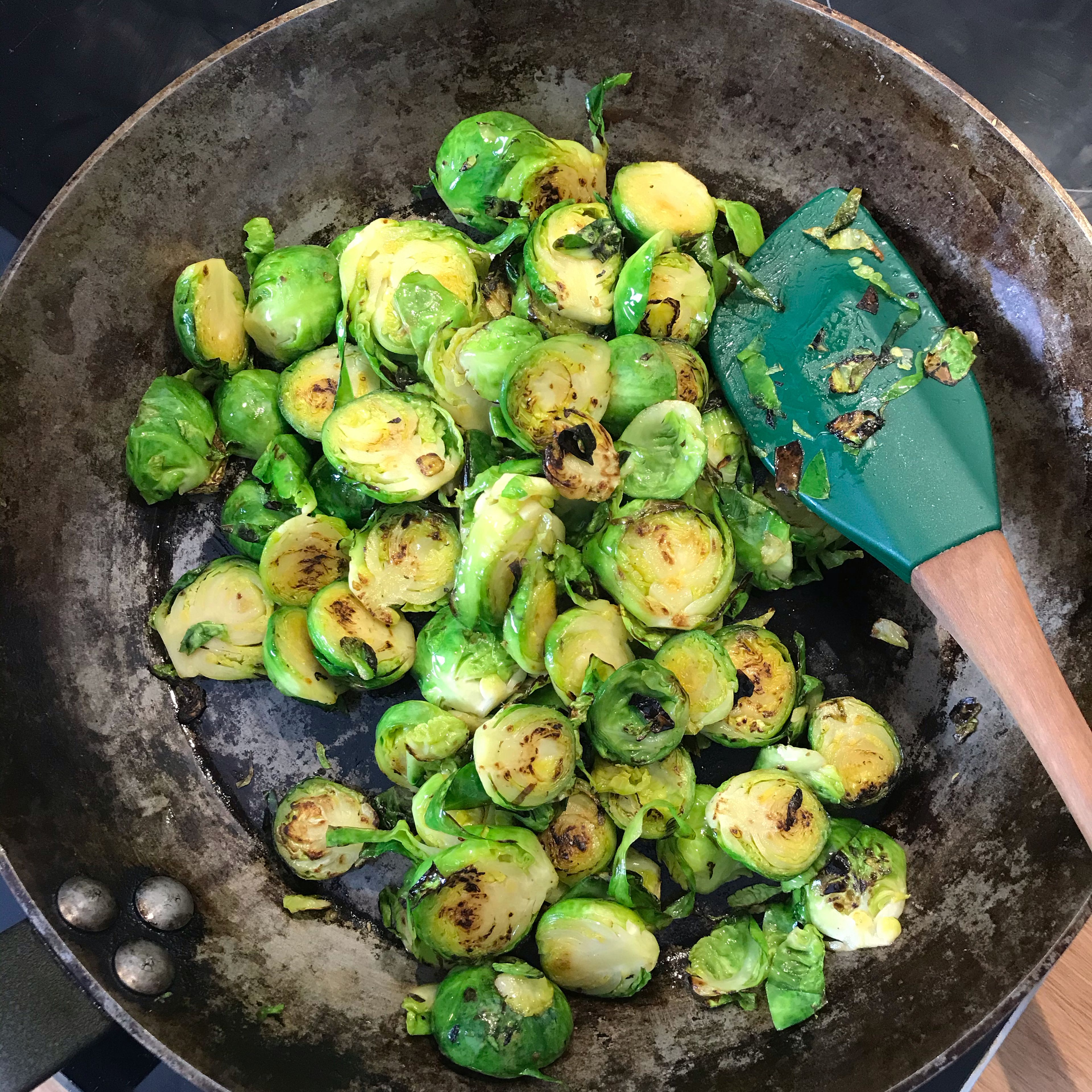 First of all, fry the coconut chips in a pan without oil. Then add sesame oil and fry the Brussels sprouts properly.