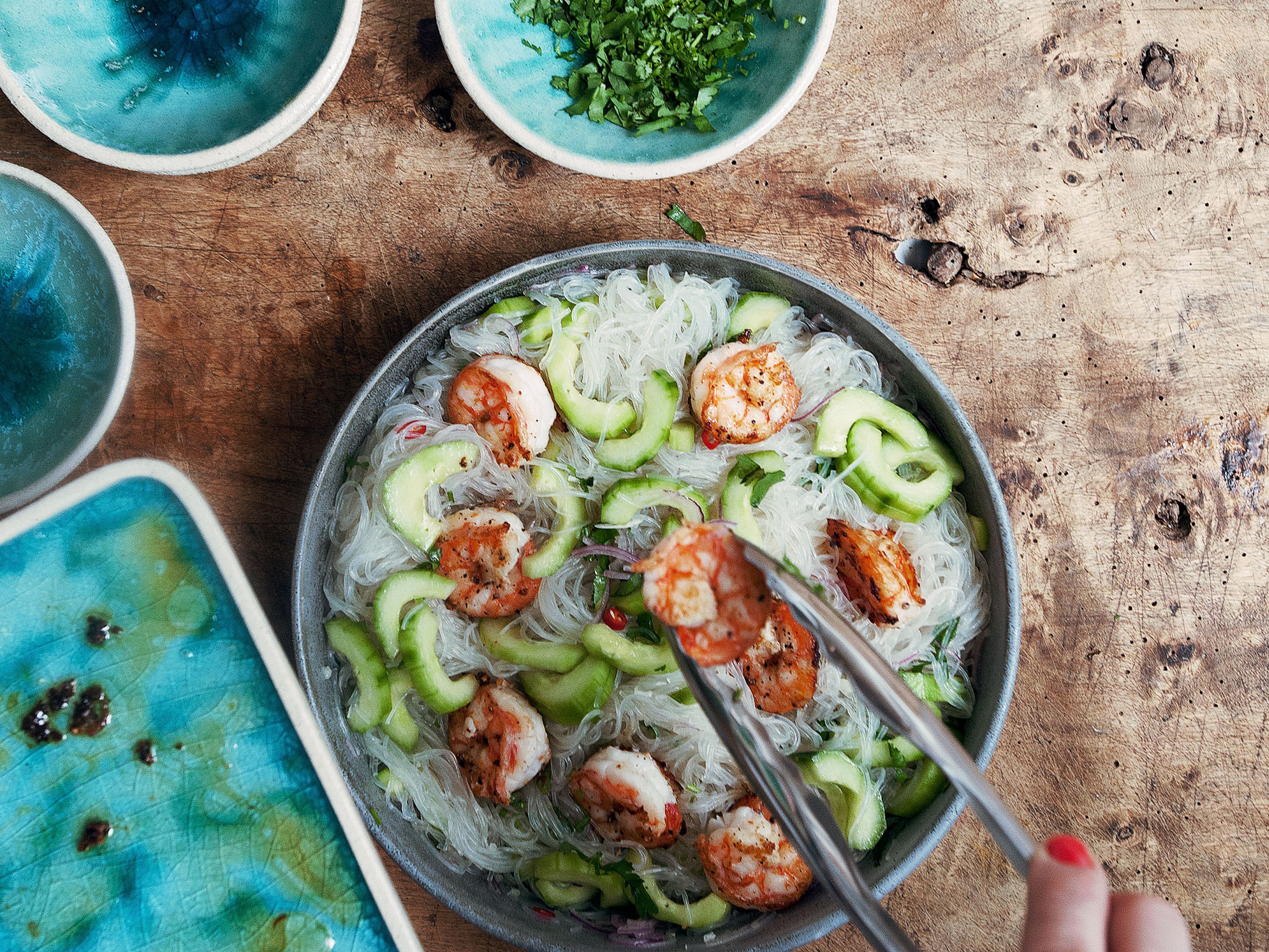 In a large bowl, combine cucumber, onion, garlic, chili pepper, toasted sesame oil, fish sauce, and lemon juice and toss. Add drained glass noodles to bowl along with shrimp. Mix everything thoroughly together. If desired, add more lime juice, sesame oil, or fish sauce to taste. Top with chopped coriander, serve and enjoy!