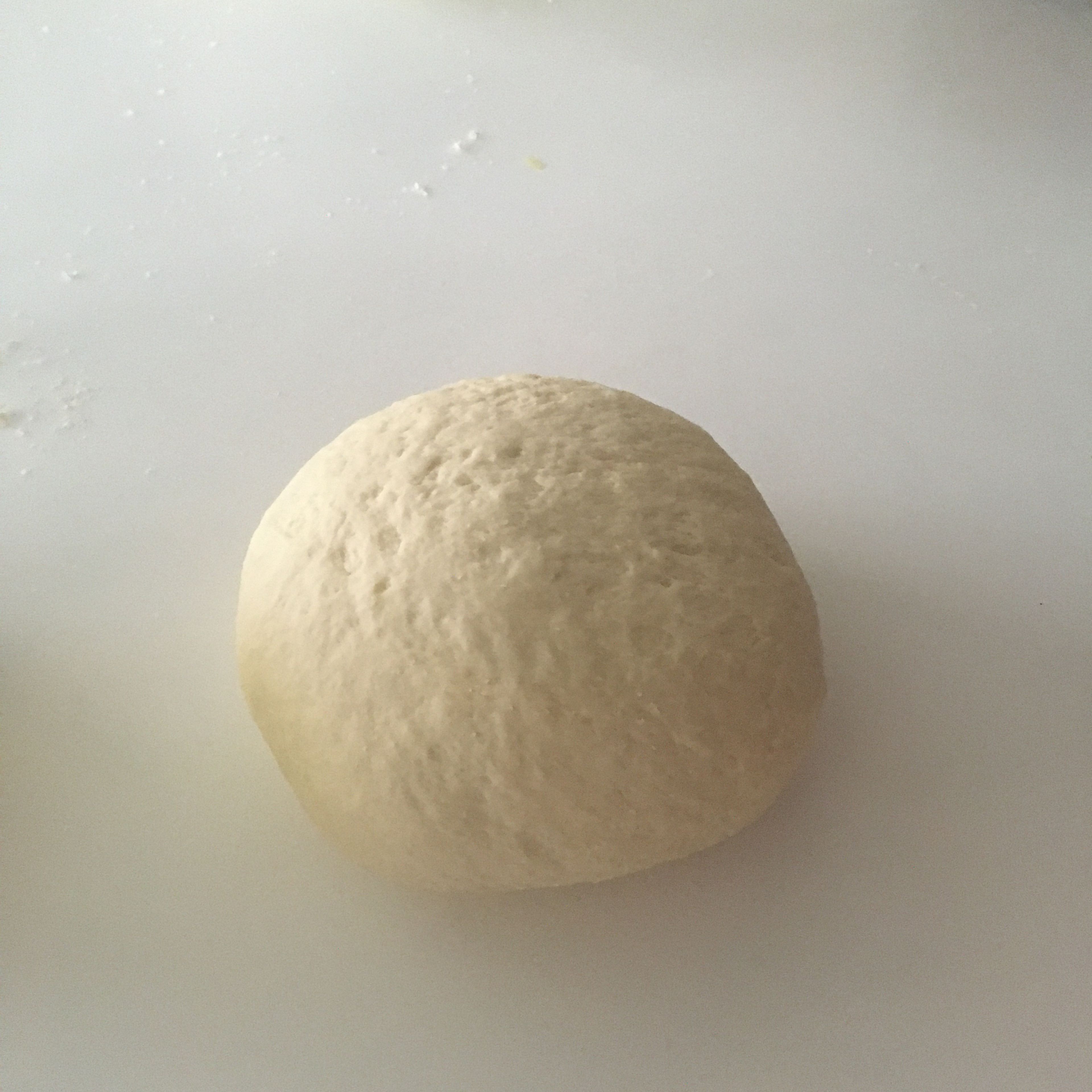 Knead the dough until you get a nice circular shape, with a sticky but firm consistency